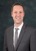 Steve Poftak in a gray suit