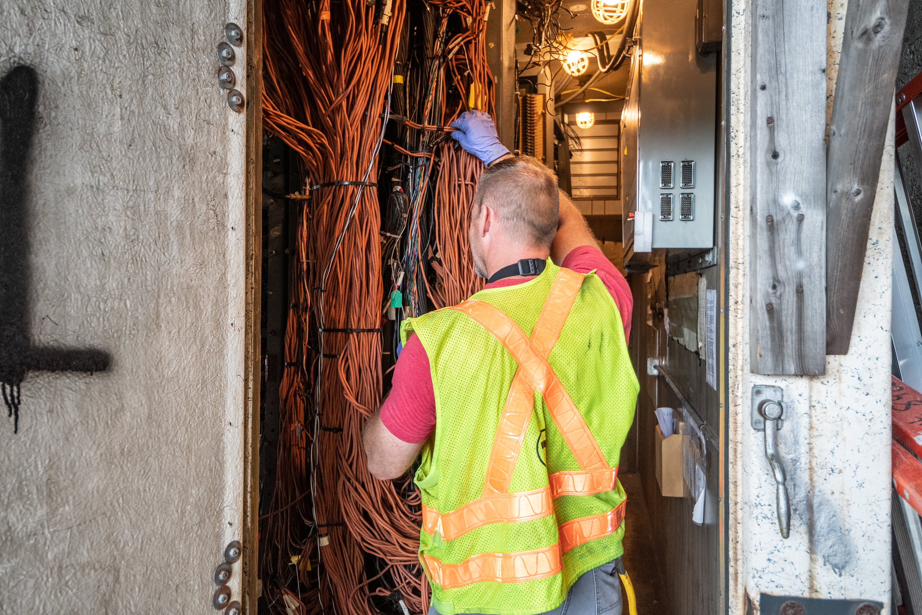 A worker makes repairs at the JFK/UMass signals bungalow