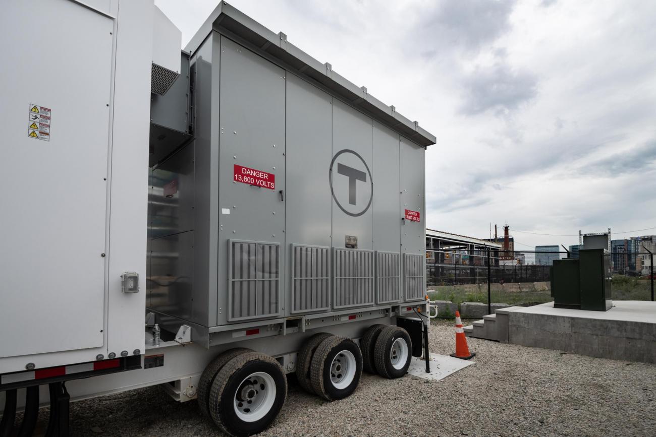 A large portable generator, with a sign that reads "Danger 13,800 Volts"