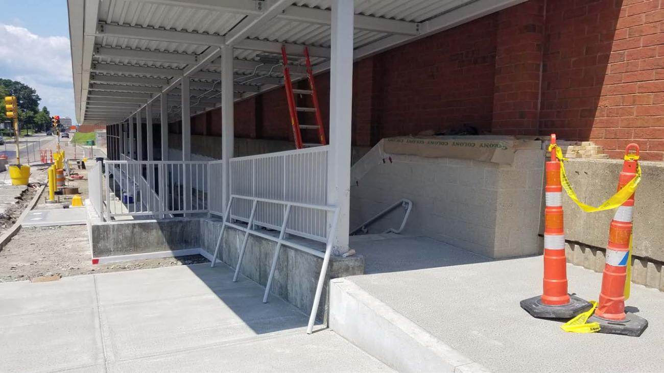 Handrails and sidewalk installed at Newport Ave outside station (July 25, 2019)