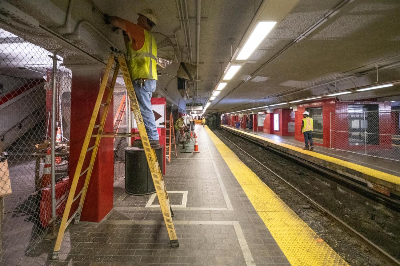 MBTA crews clean and repair the walls and ceiling of the Red Line platform at Park Street Station.