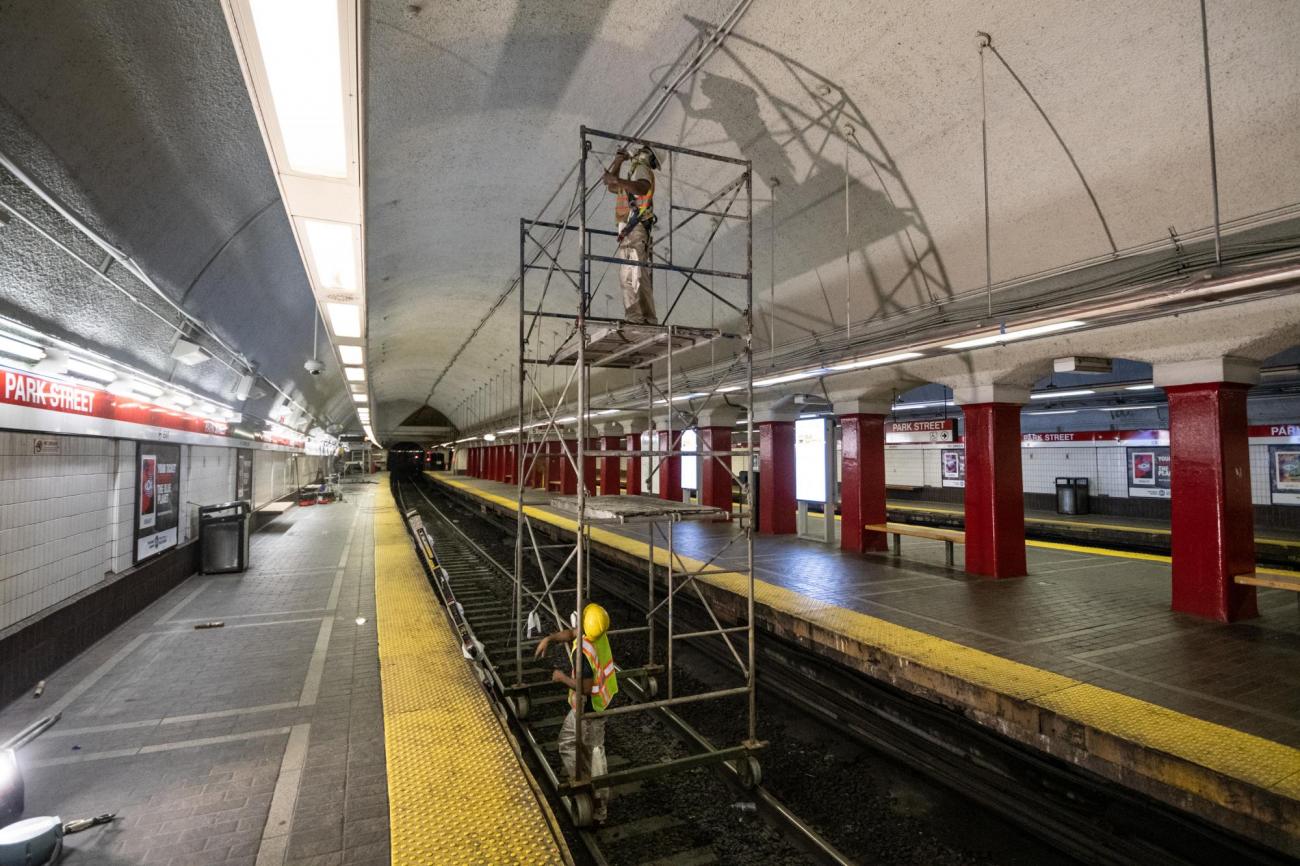 MBTA crews clean and repair the ceiling above the Red Line platform at Park Street Station