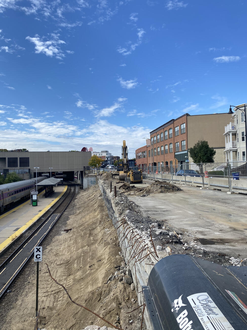 View of partially demolished retaining wall along Somerville Avenue in Cambridge.