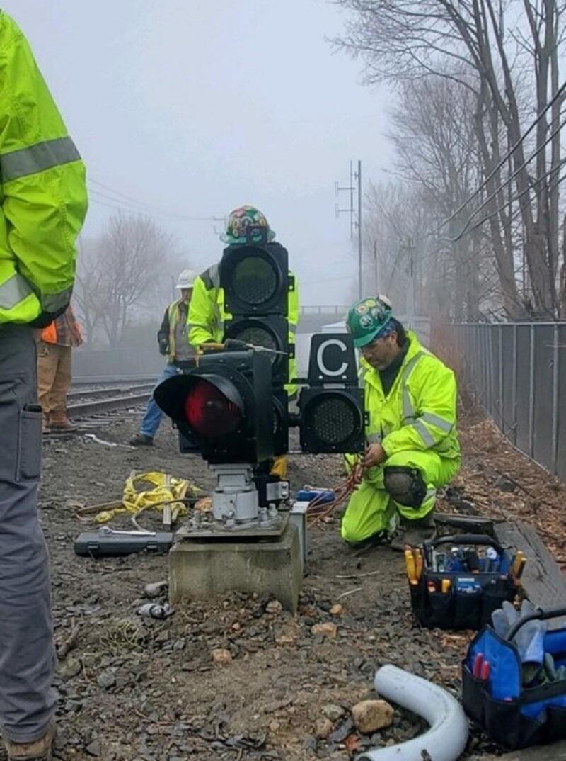 Image of crews installing ATC signal along tracks on Newburyport Line