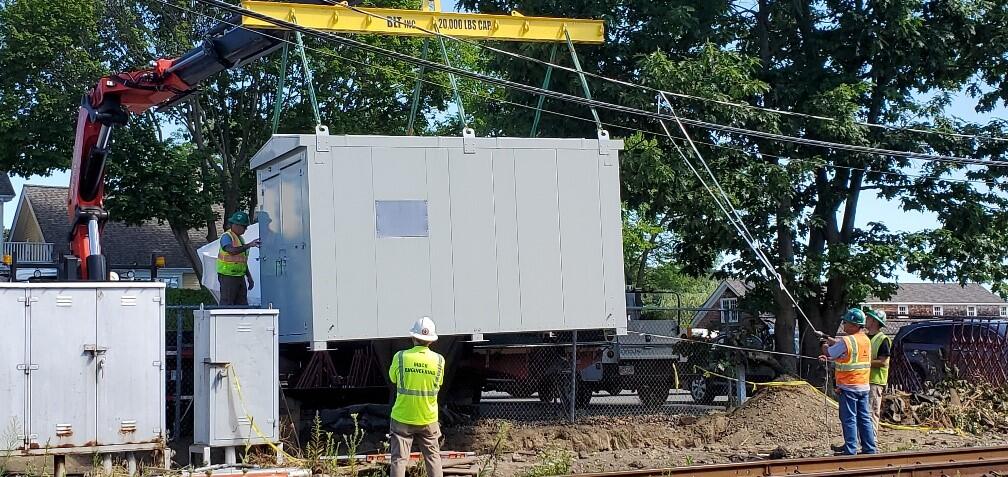 Crews install a new ATC signal house on the Newburyport Line