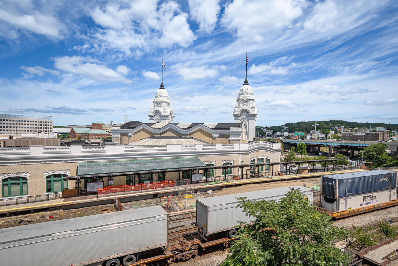 A view of Worcester Union Station from the south. You can also see the construction site of the new platform and shipping containers on the train tracks.
