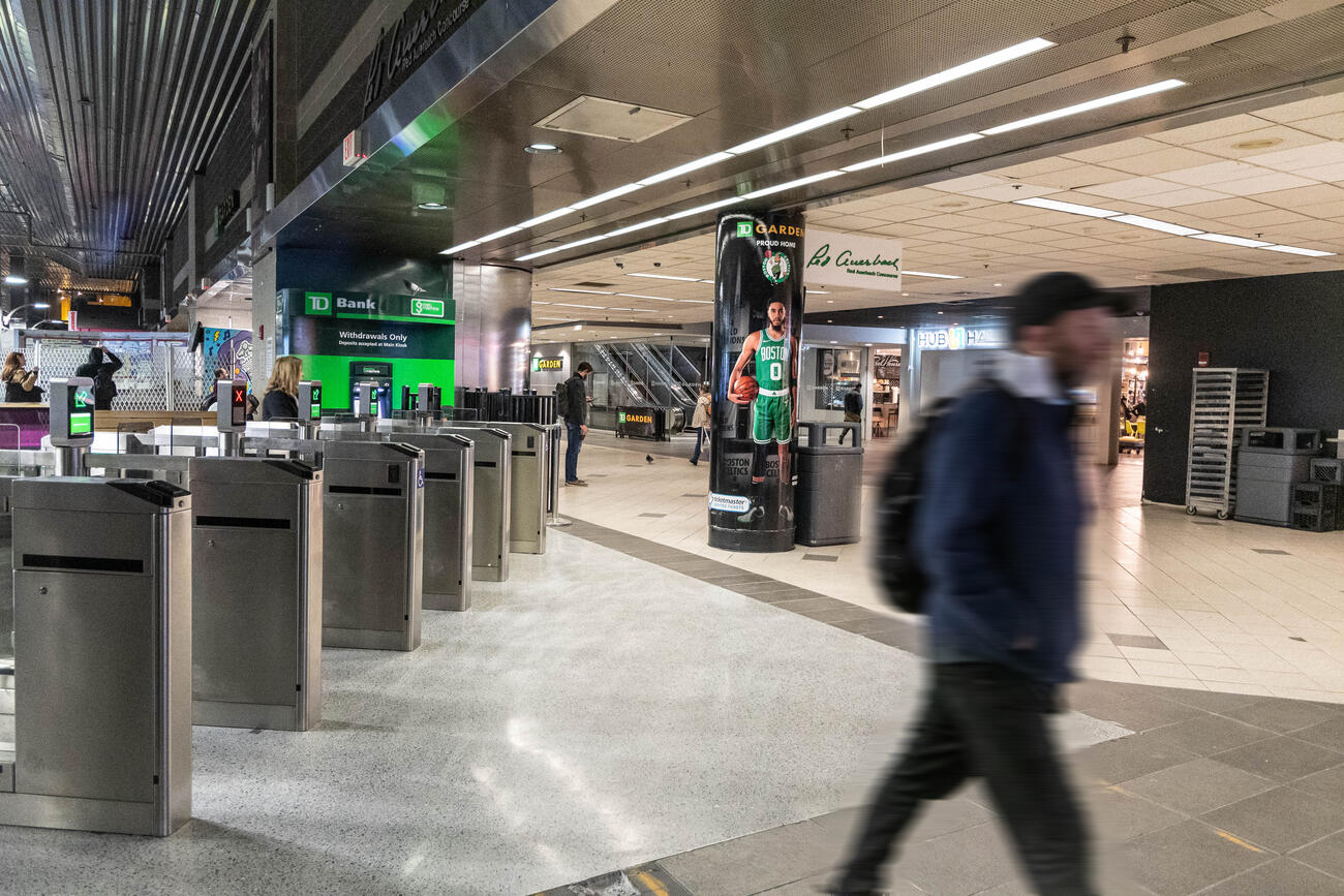 Riders exiting new North Station fare gate
