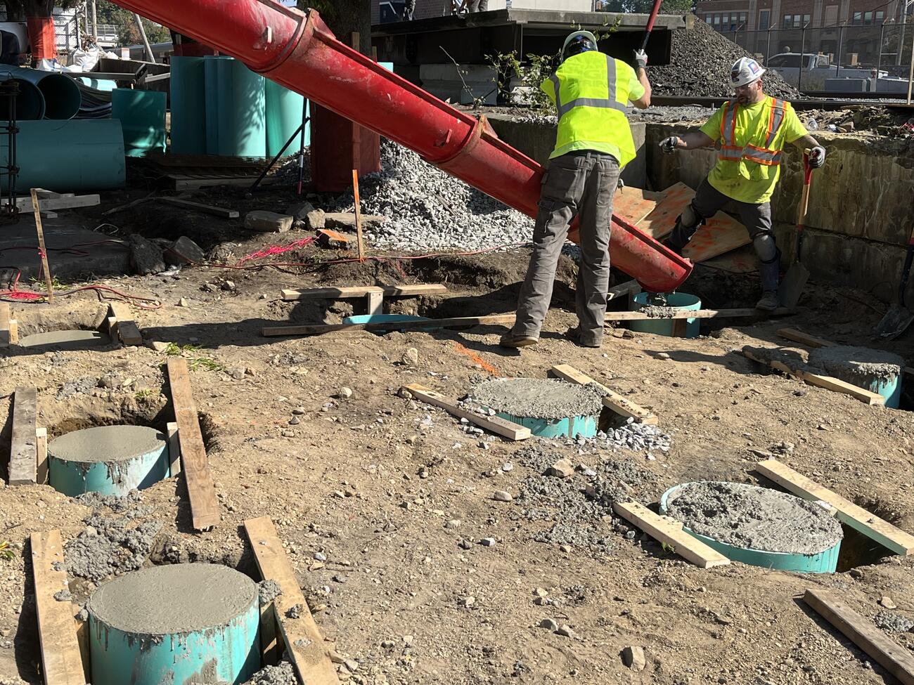 Crews pouring concrete foundations