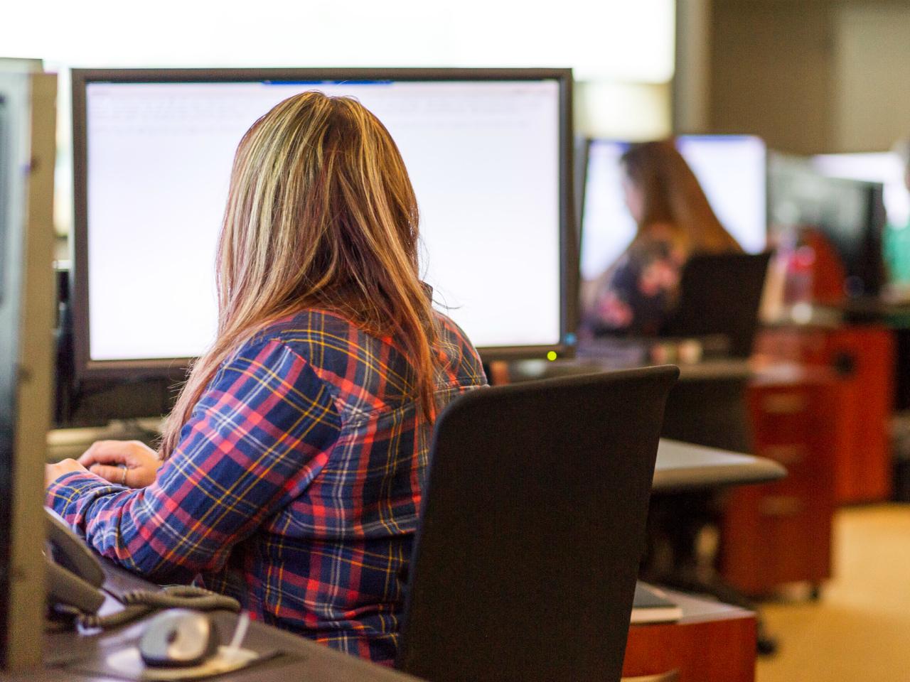 MBTA staff seated in front of computer monitors