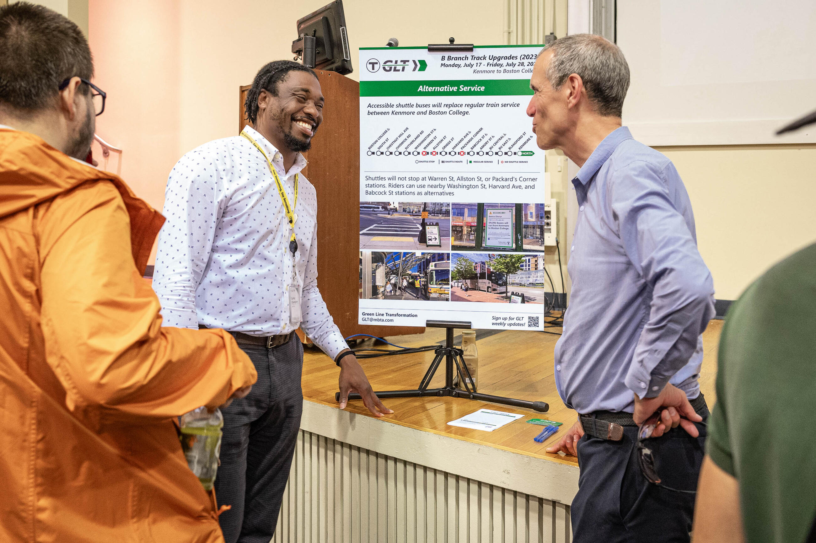 Community members in front of Green Line Transformation signage