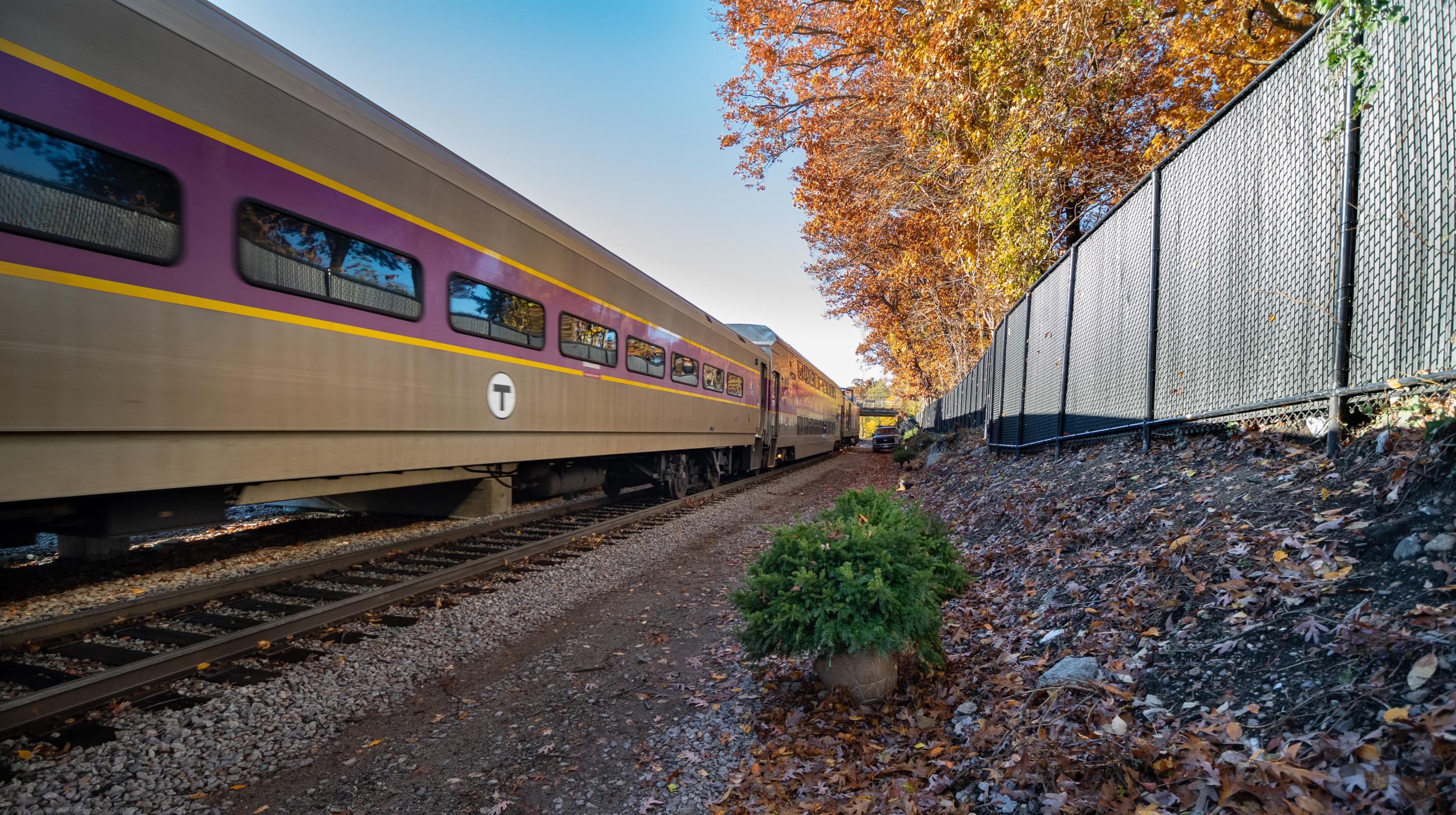Commuter Rail Train Drives Through Blue Hill Avenue Station in Fall