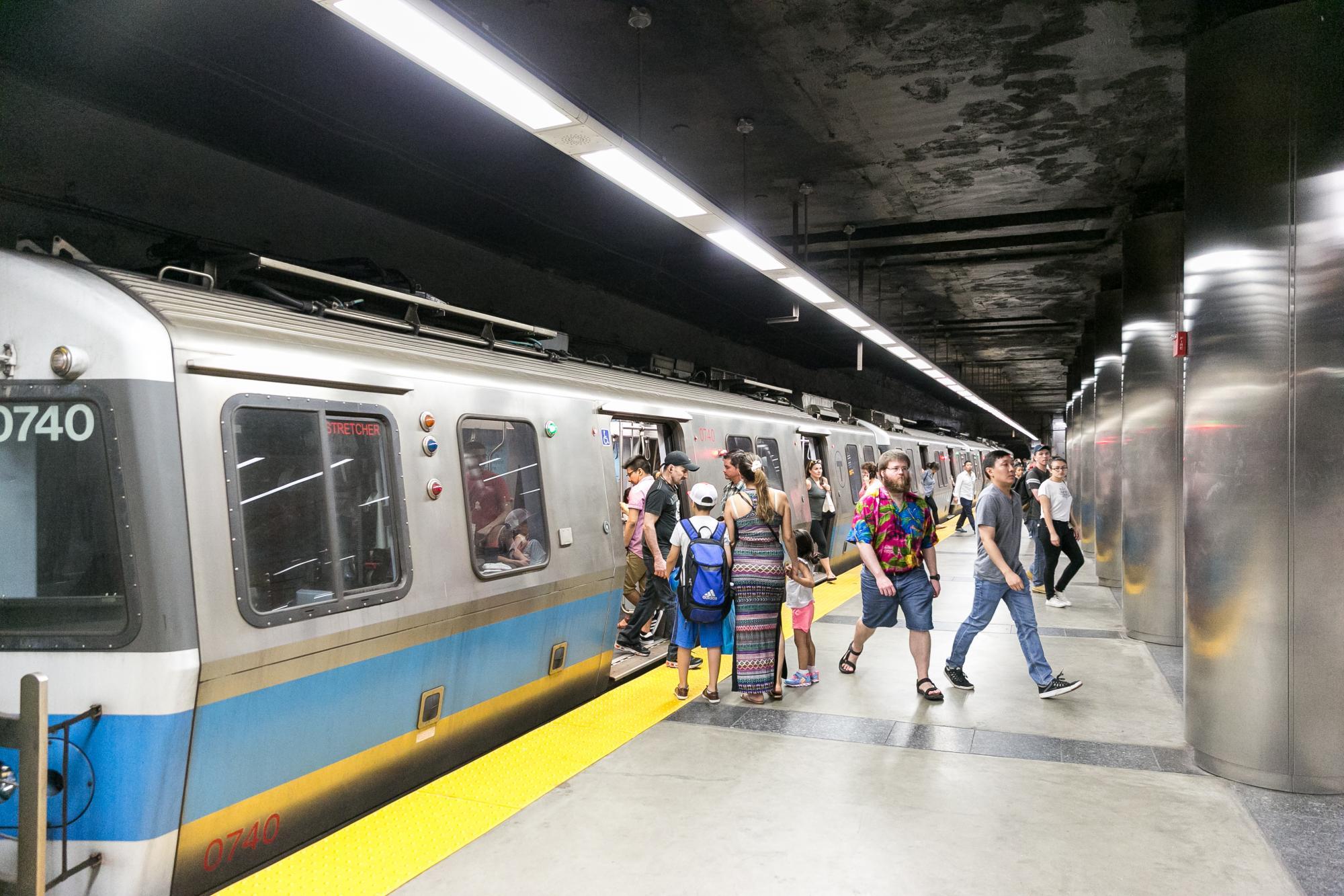 Riders boarding and existing a Blue Line train at Maverick, on the outbound platform.