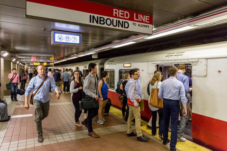 Riders board a Red Line train on the inbound platform of South Station