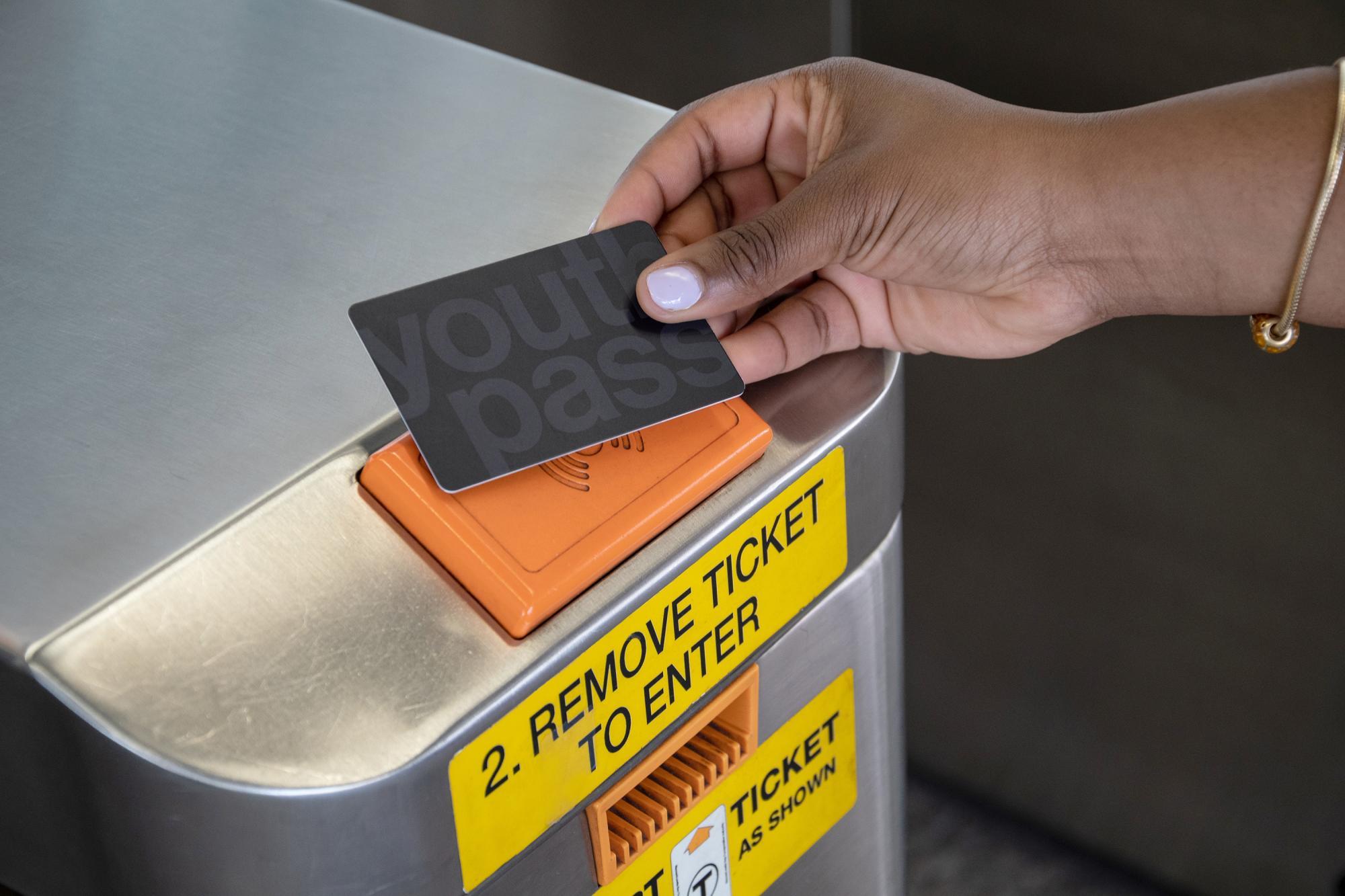 Tapping the new Youth Pass card on a subway fare gate