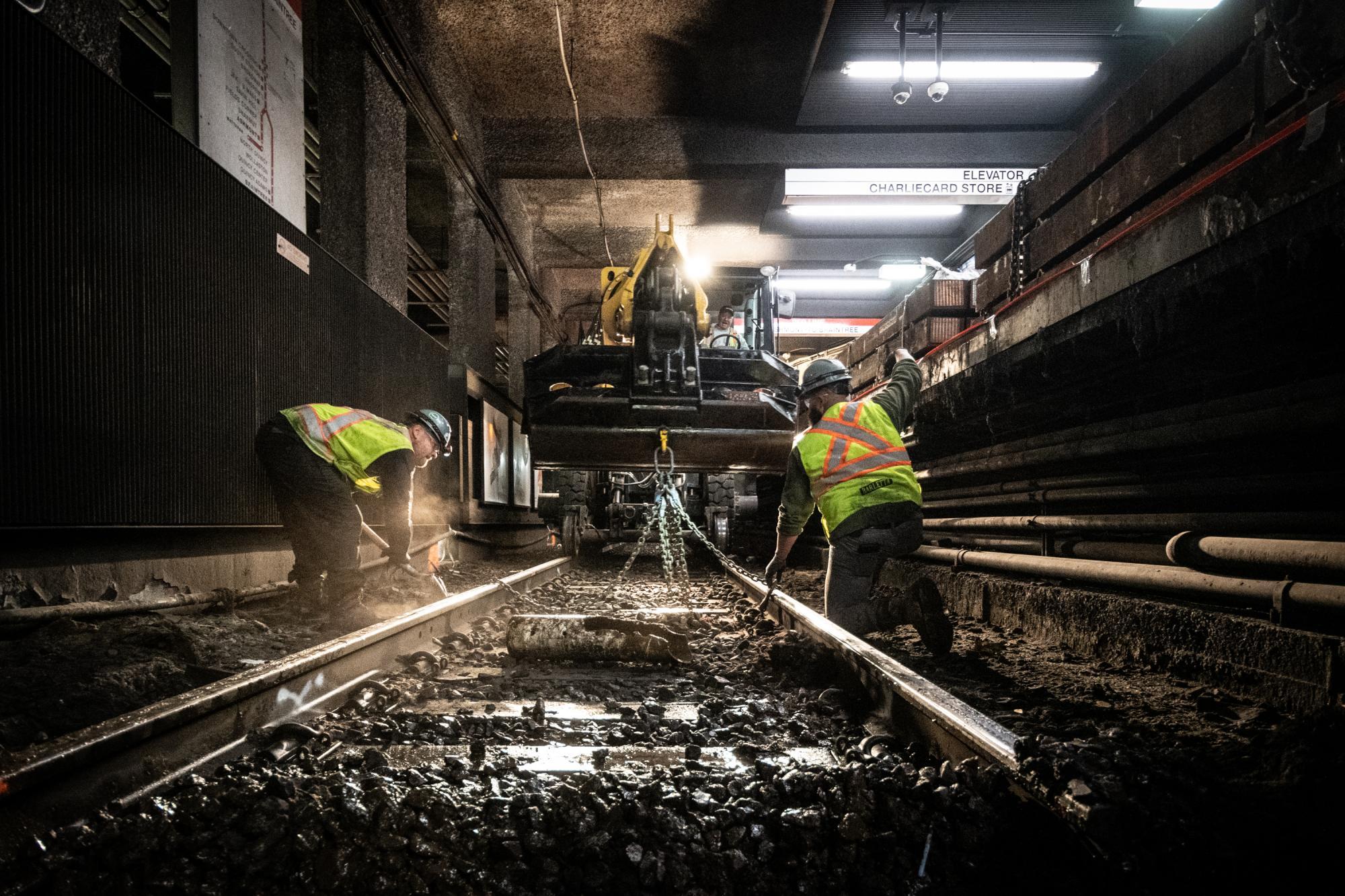 Crew members lay track on the southbound side of Downtown Crossing during the November 22 – 24 weekend shutdown
