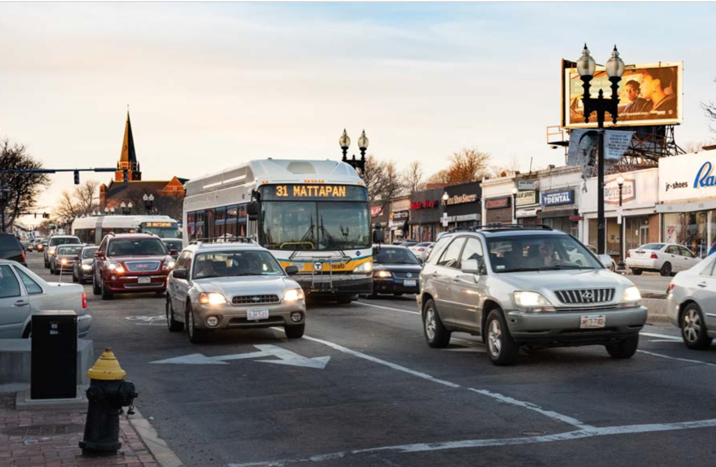 A bus drives in traffic in Mattapan
