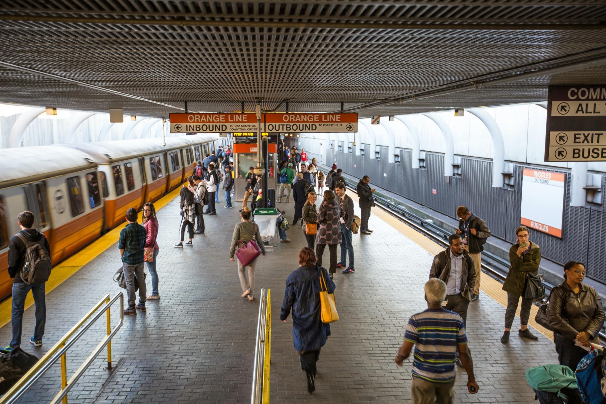 customers on the orange line platform at ruggles T stop