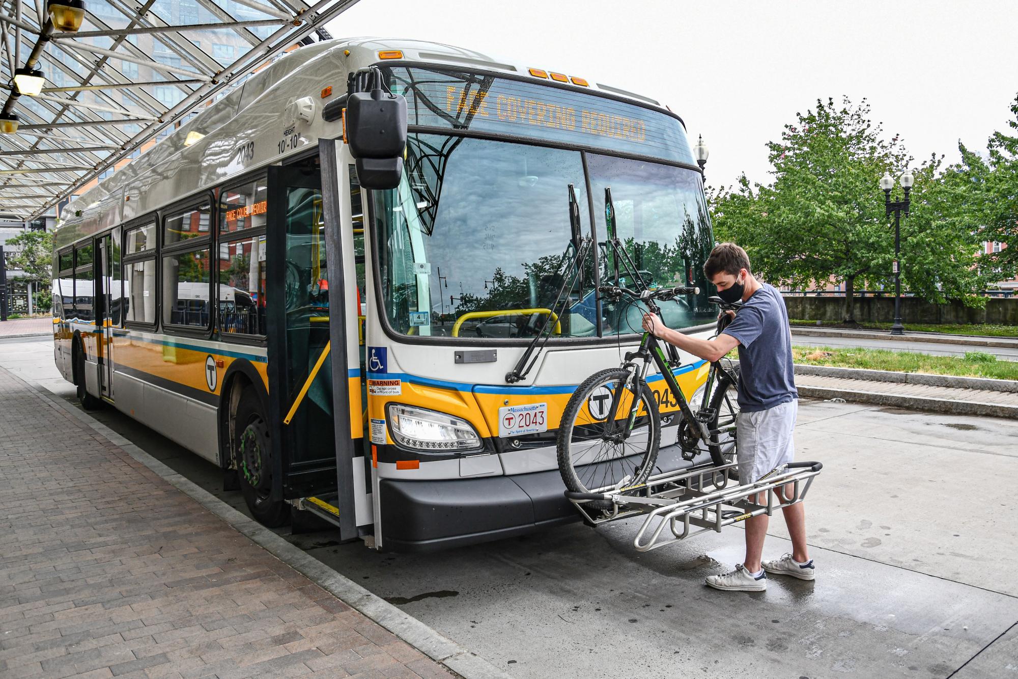Bikes | A man places his bike into a bus bike rack | Haymarket | (July 2020)