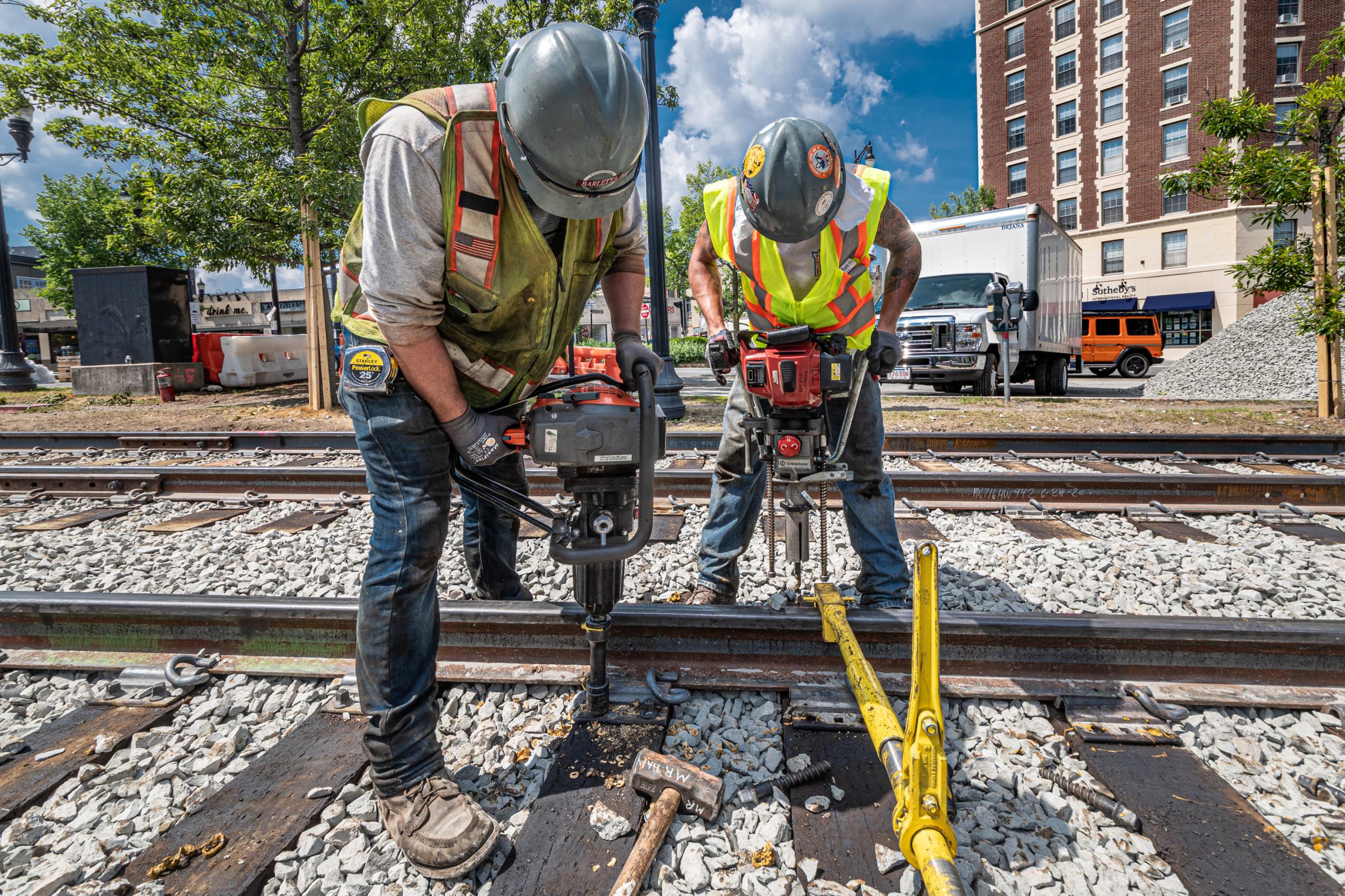 Crew members aligning rail and replacing rail ties on the Green Line C