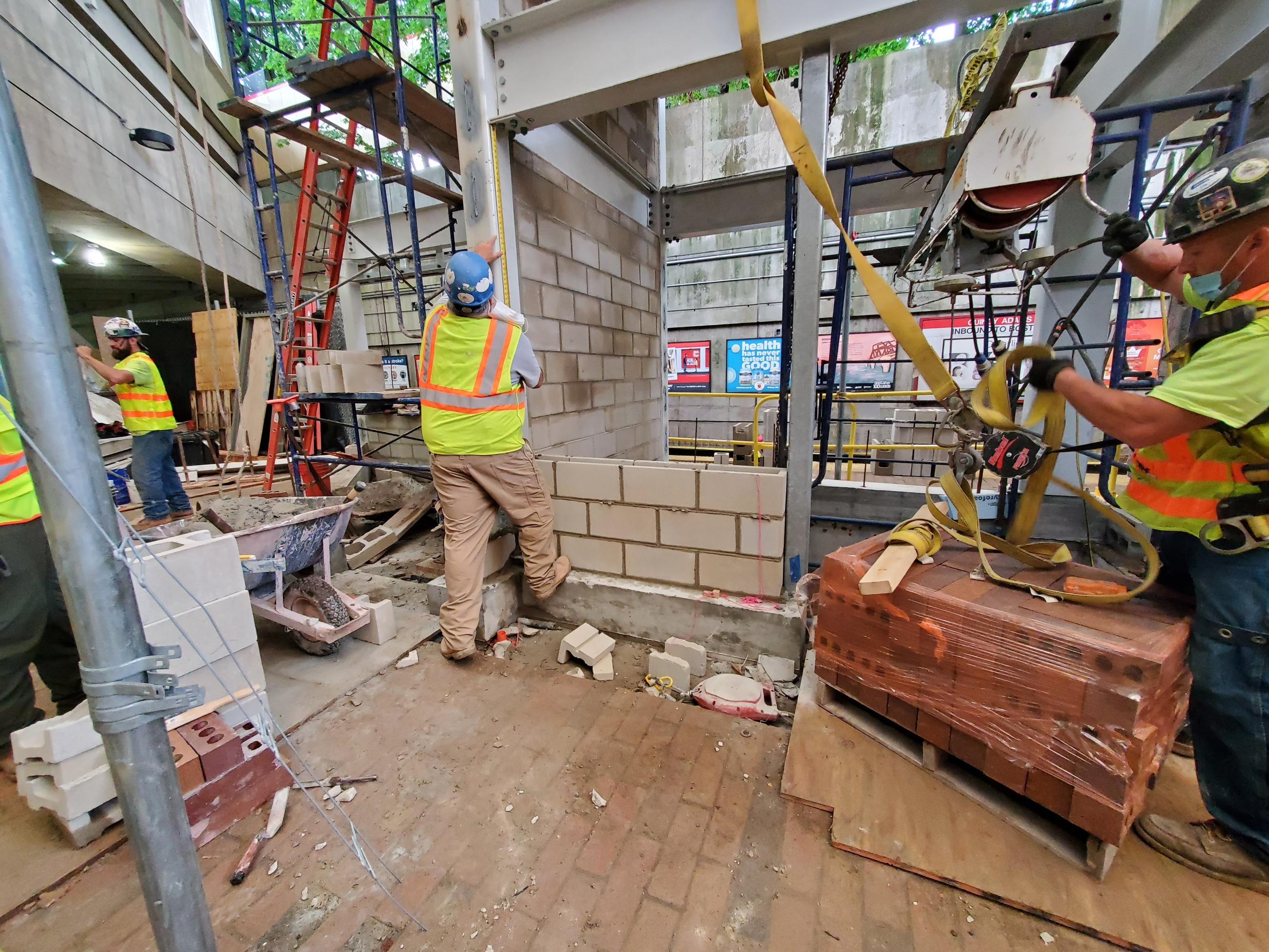 A construction crew working on the Red Line platform at Quincy Adams Station.