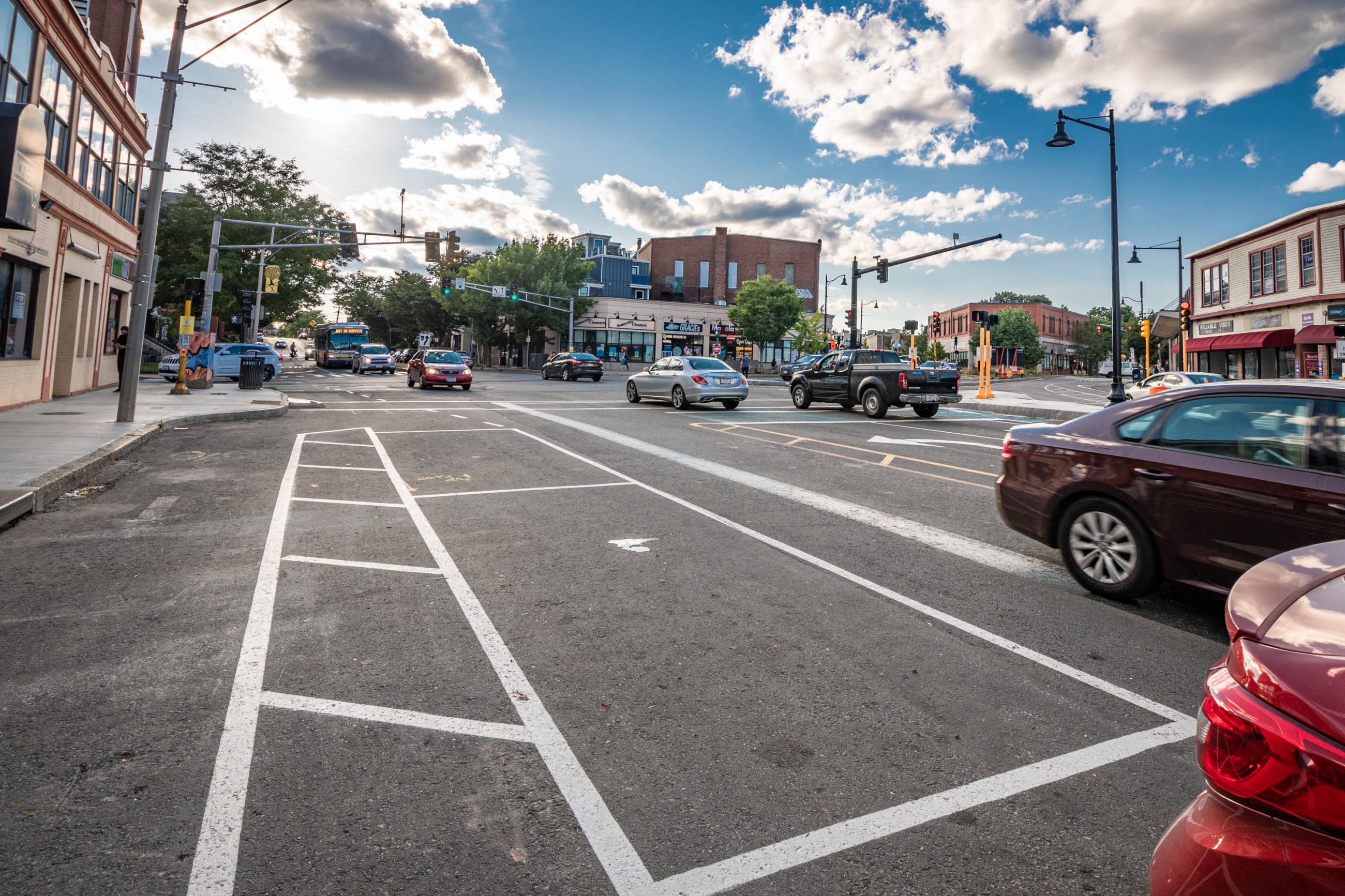 View of Washington Street in Somerville on a partially cloudy September day. Moderate traffic conditions, no pedestrians.