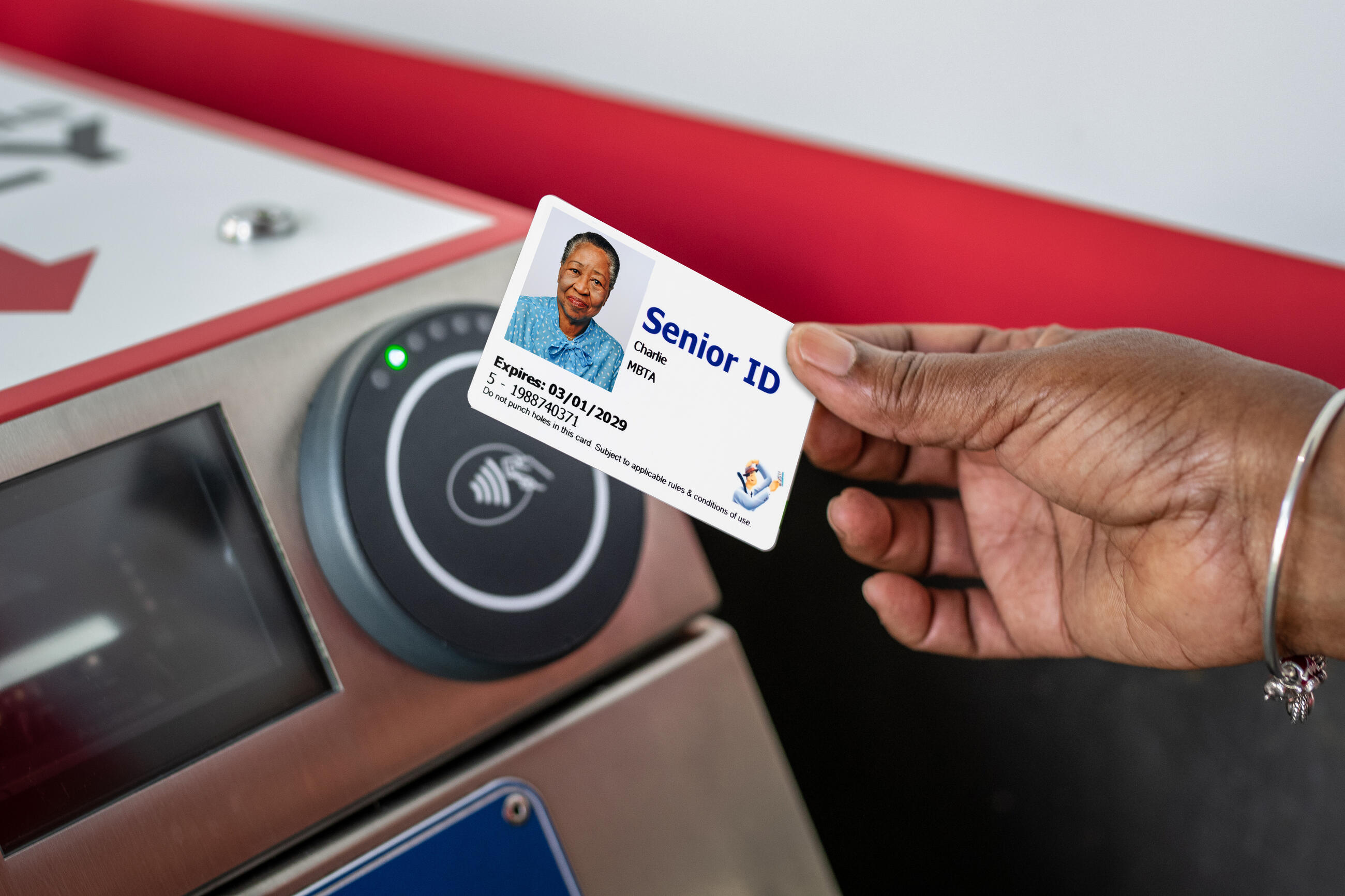 A rider uses a reduced fare Senior CharlieCard on the Red Line