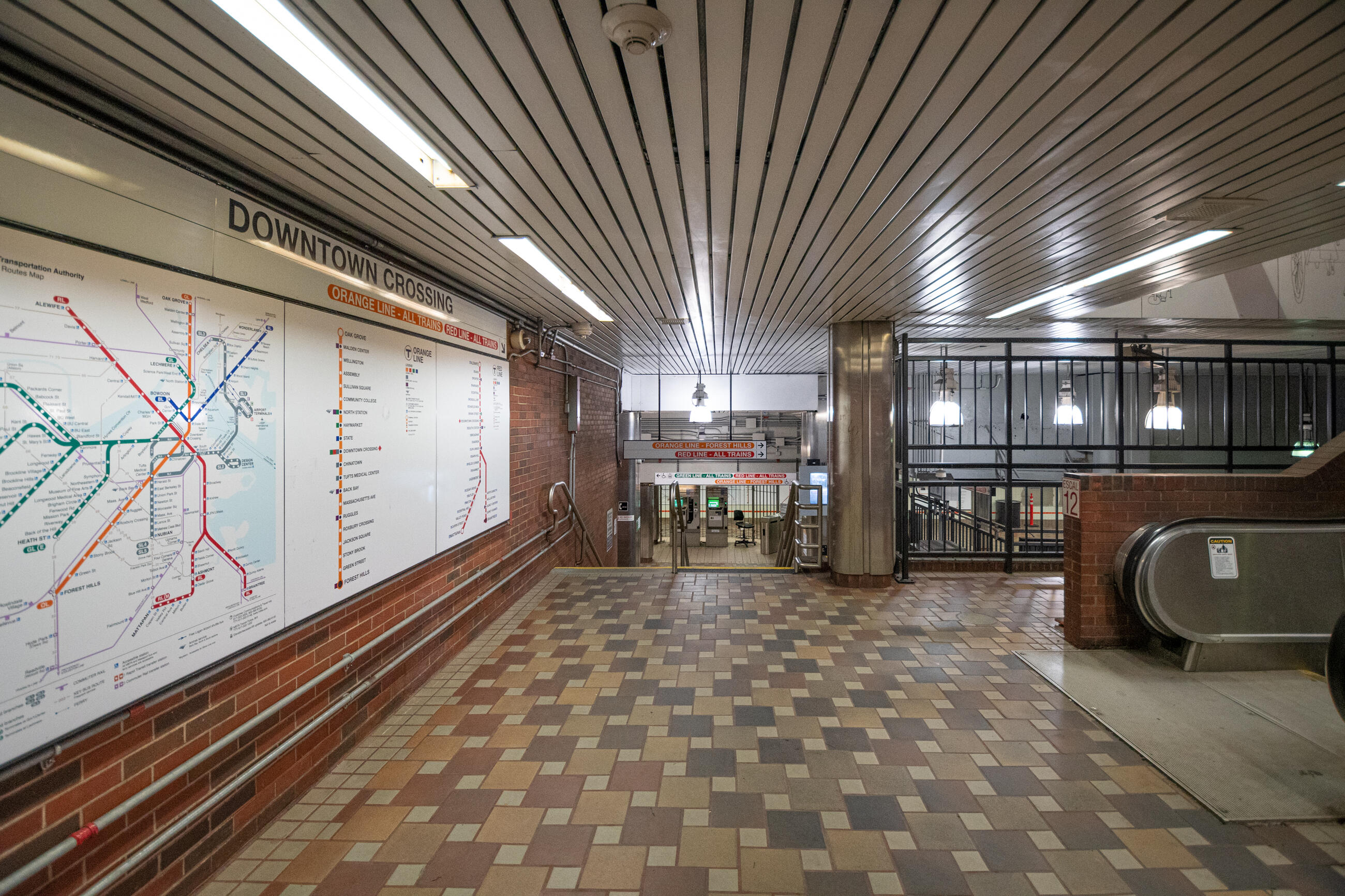 A big station map inside Downtown Crossing station. Stairs lead down to the fares and platform area