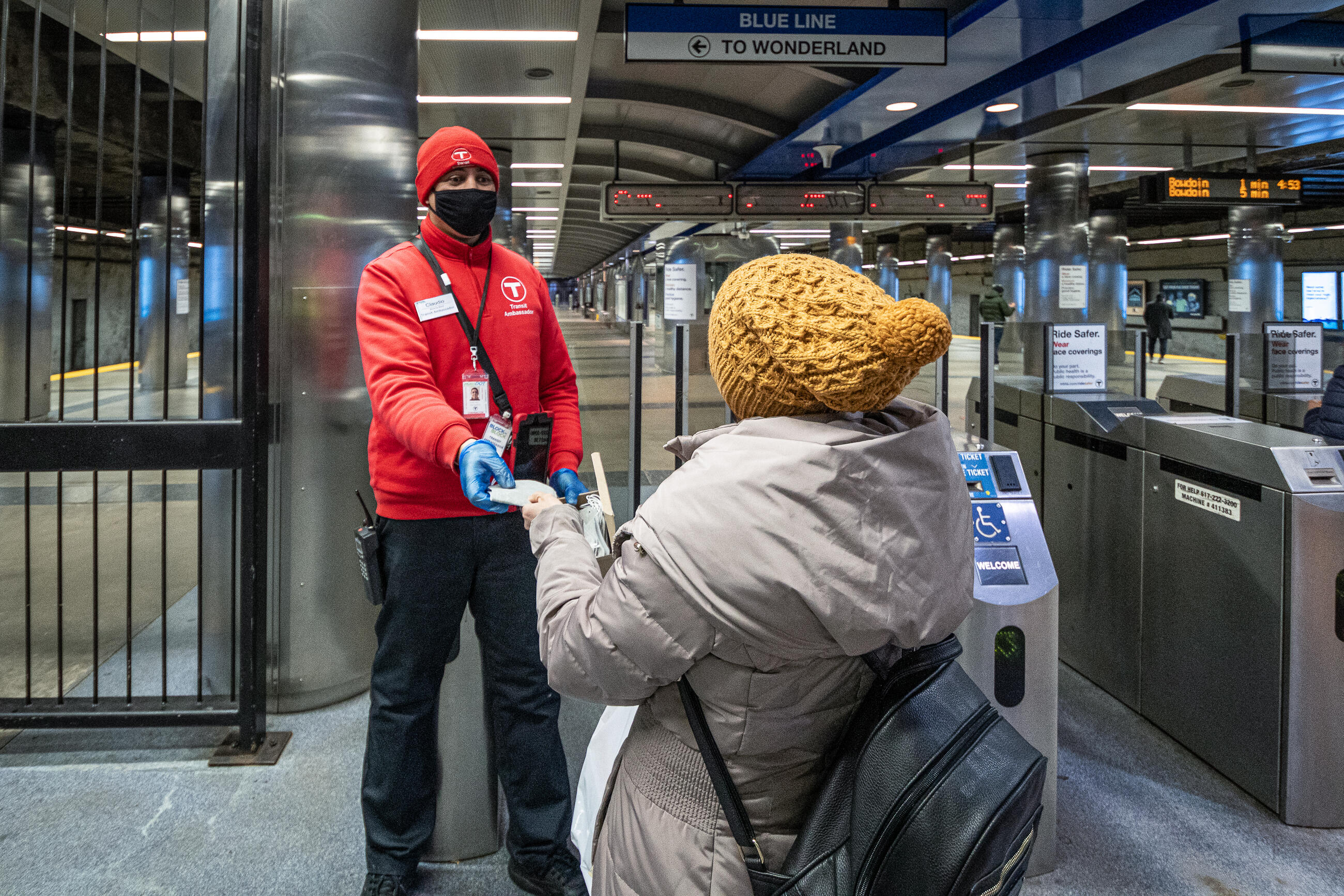 T employee with customer at Wonderland Station