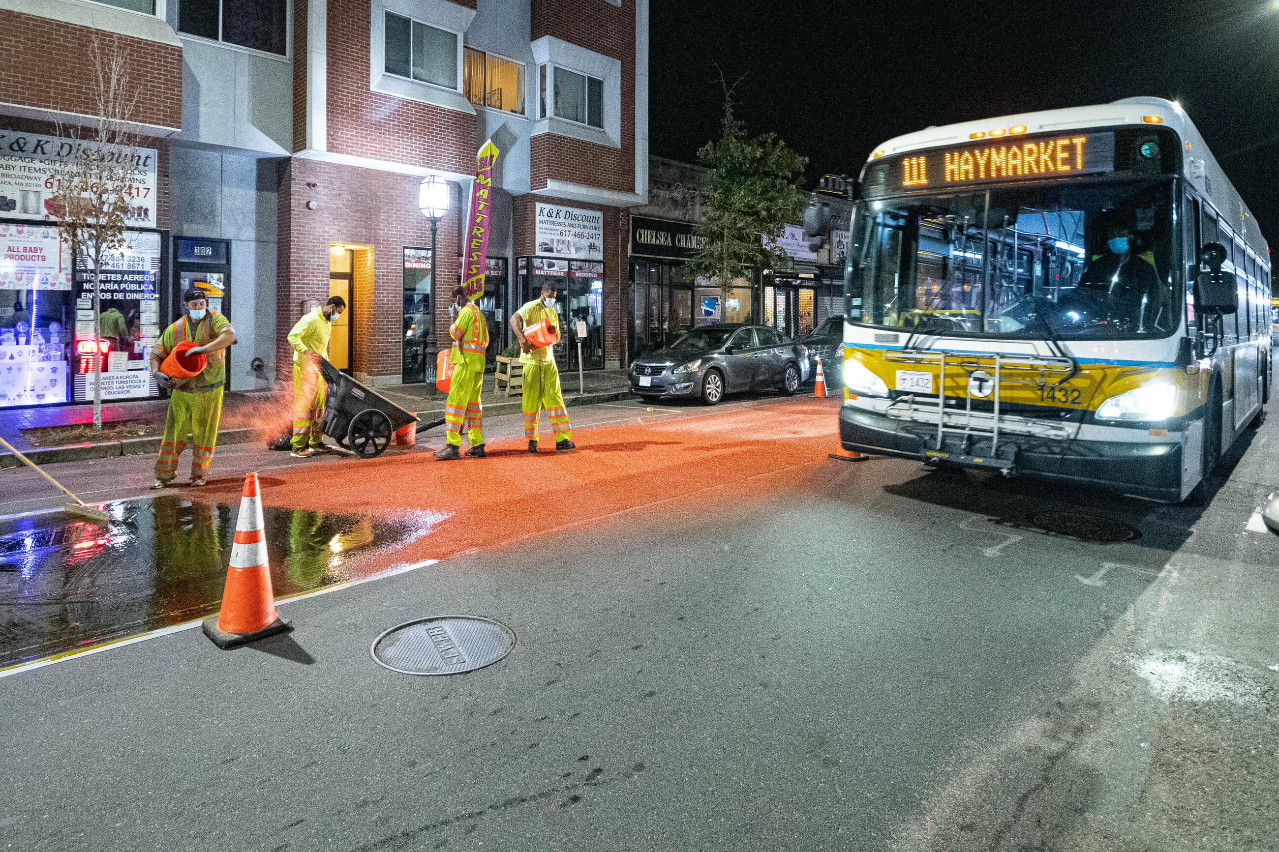 Construction crews installing bus lane markings on Broadway in Chelsea on October 21, 2020. 
