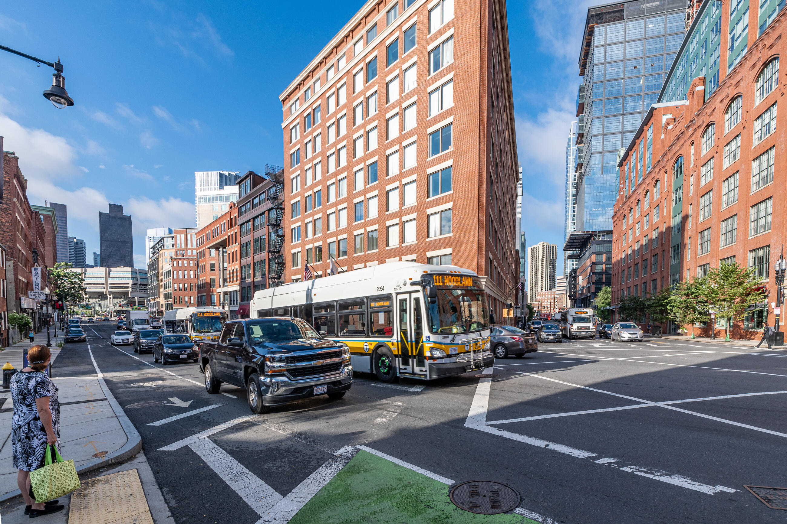 Two Route 111 buses travel along a congested stretch of North Washington Street near Causeway Street in Boston before construction of a northbound bus lane. 