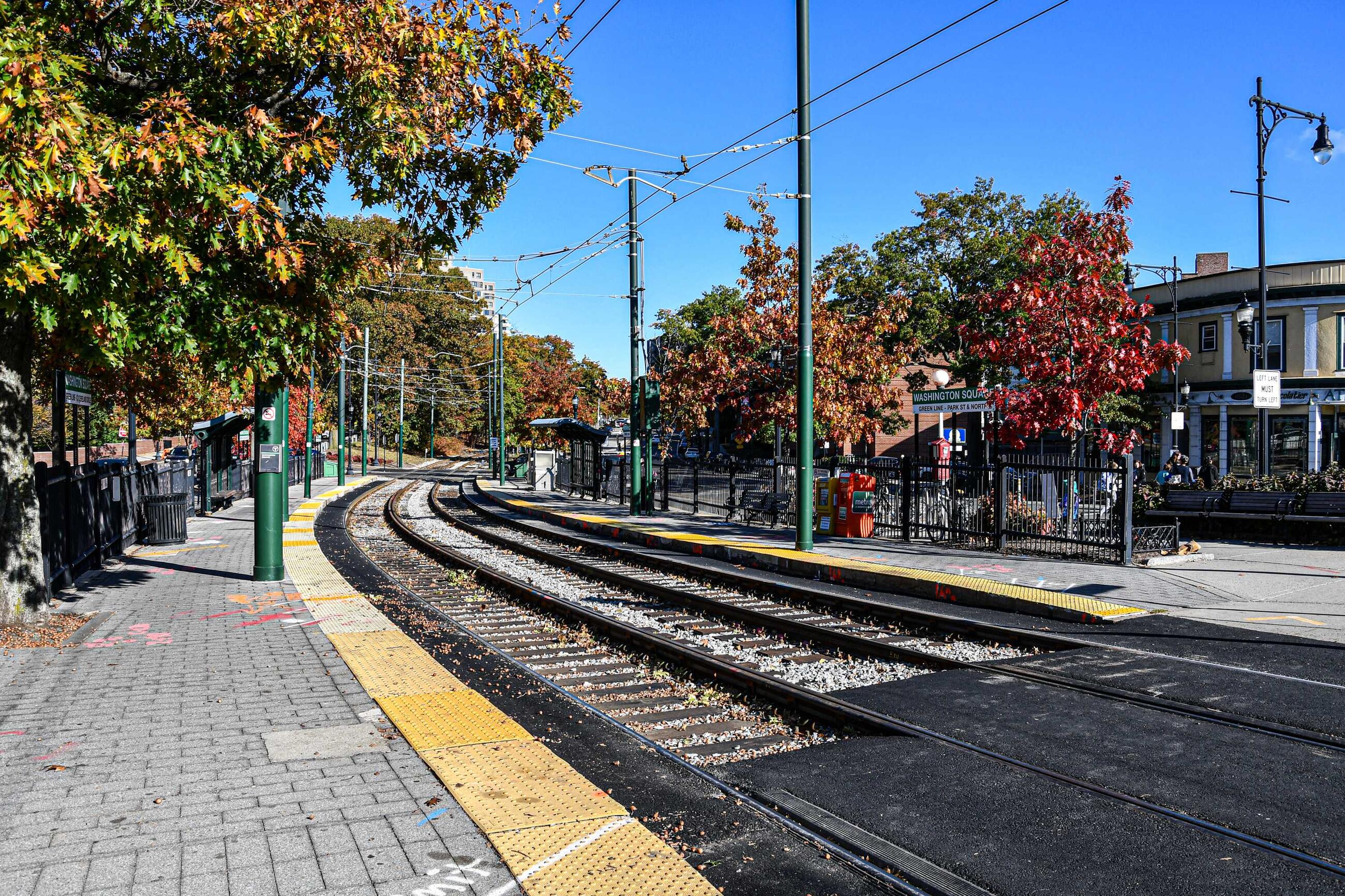 Green Line tracks at Washington Square station surrounded by foliage