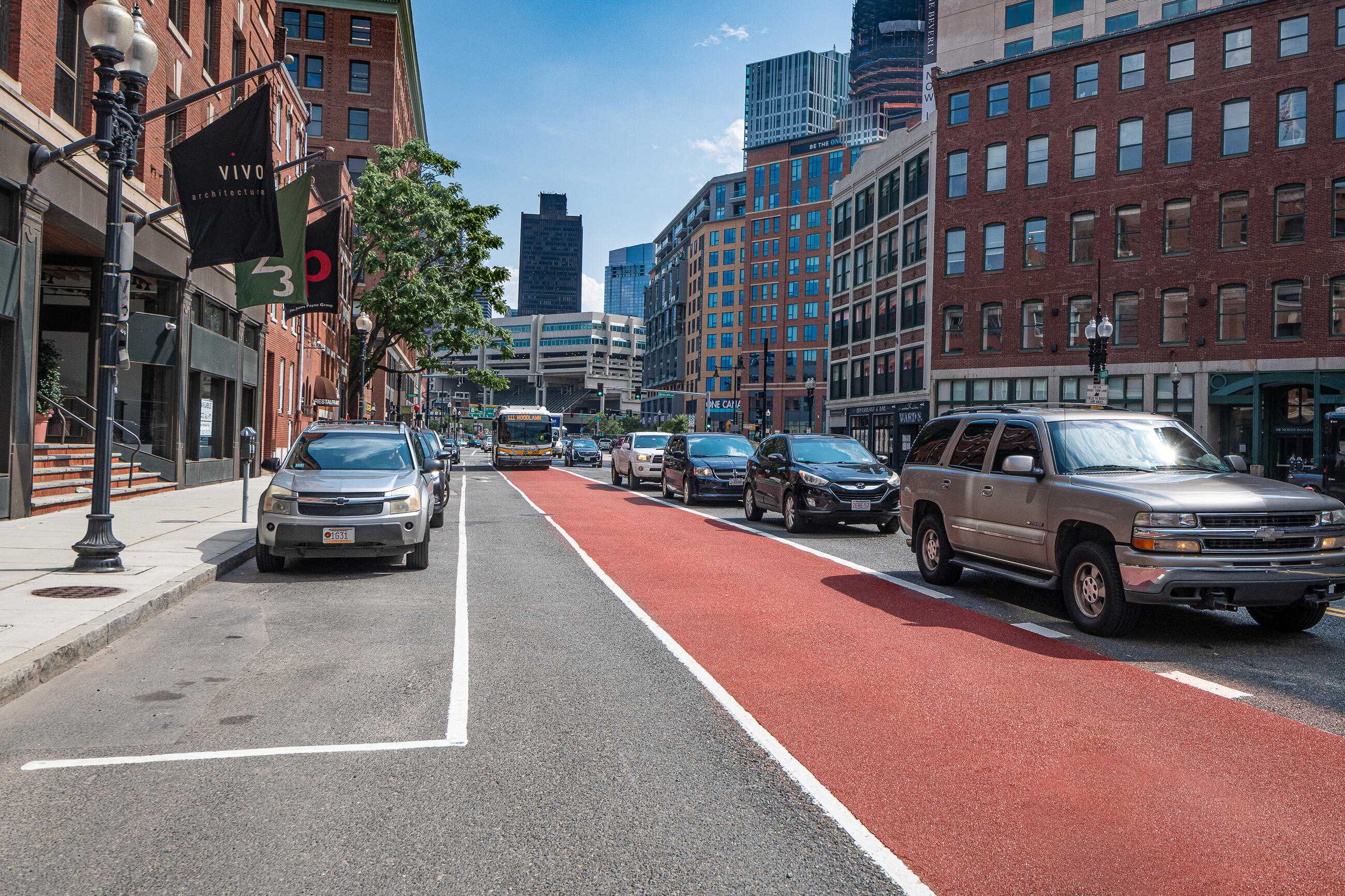 A Route 111 bus travels along North Washington Street opposite Medford Street after construction of a northbound bus lane in July 2021.