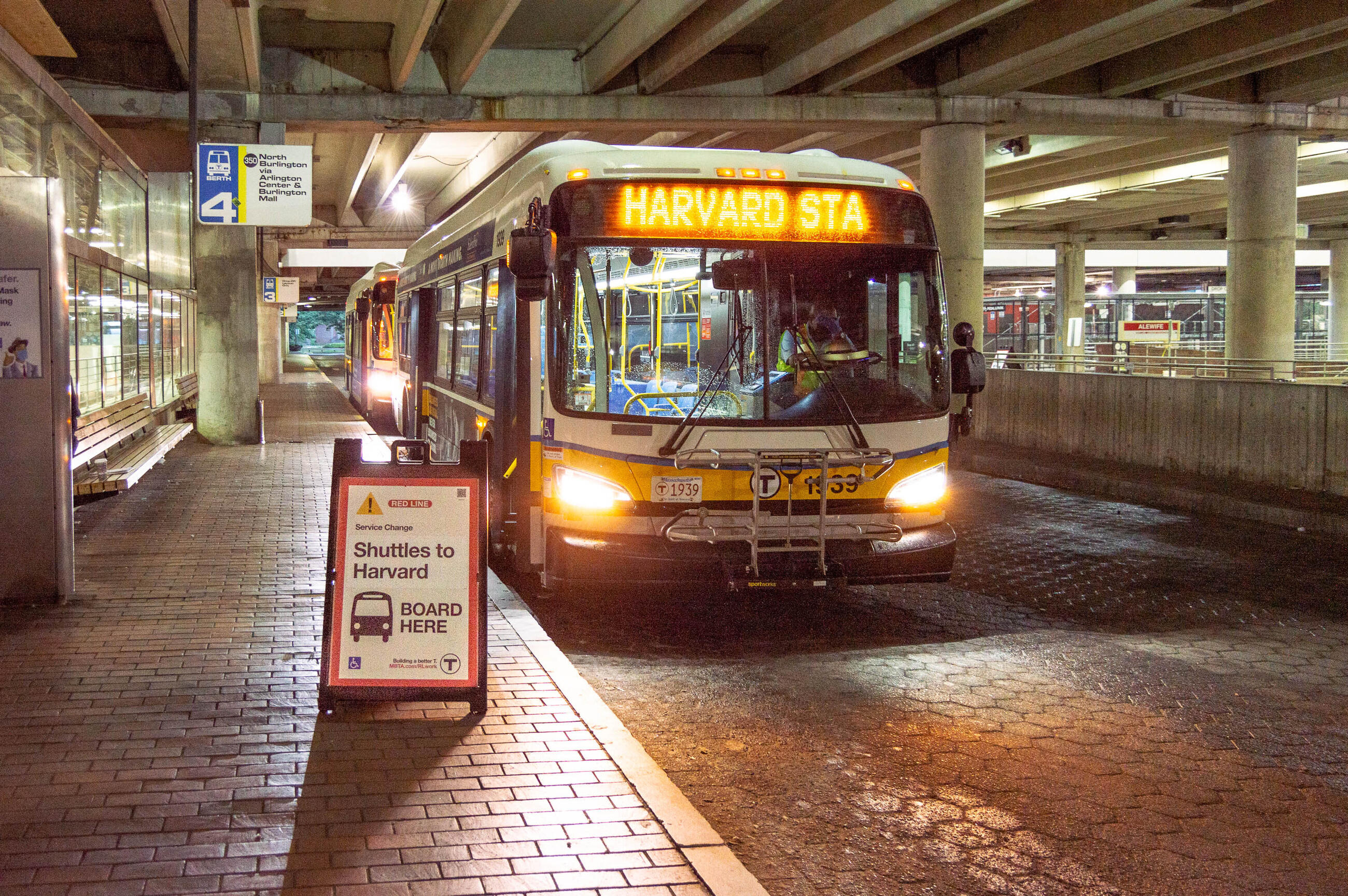a shuttle bus heading to Harvard waits at the Alewife busway