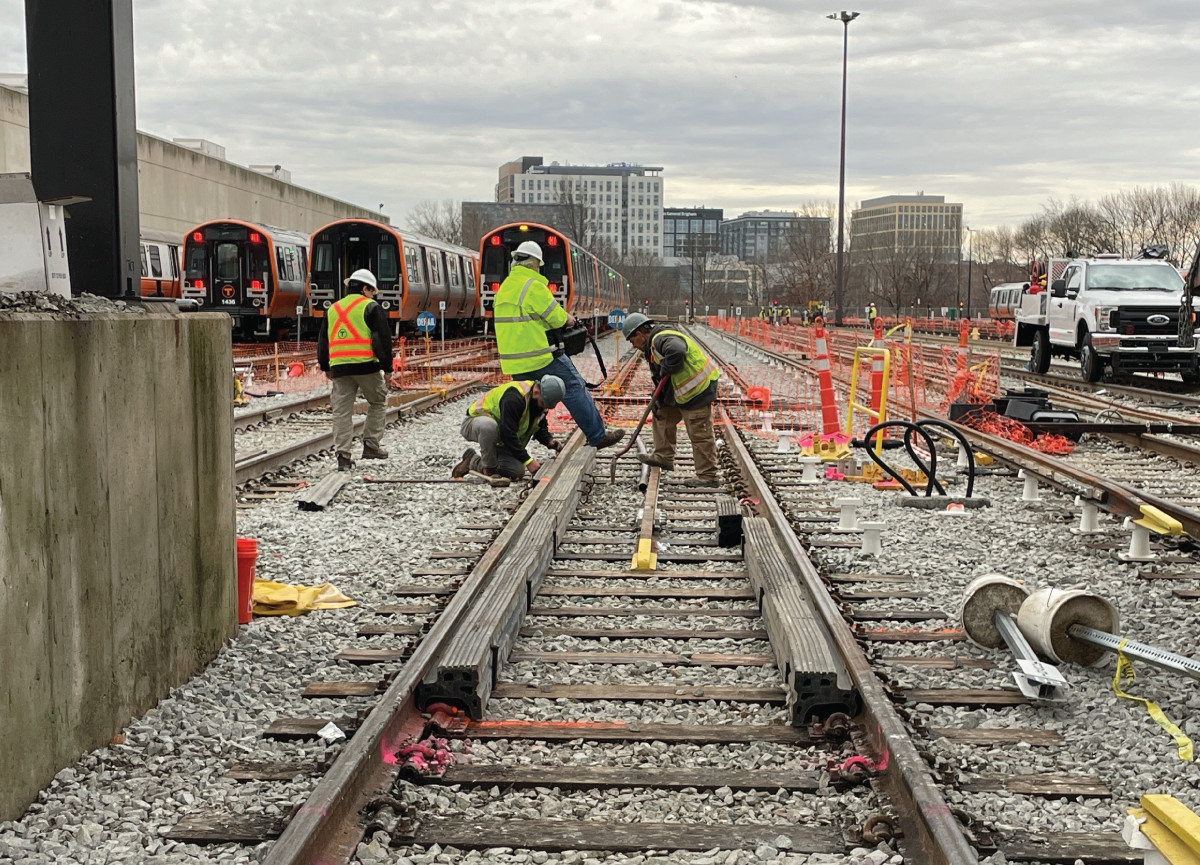 Crews work on the tracks at Wellington as part of the Orange Line Transformation