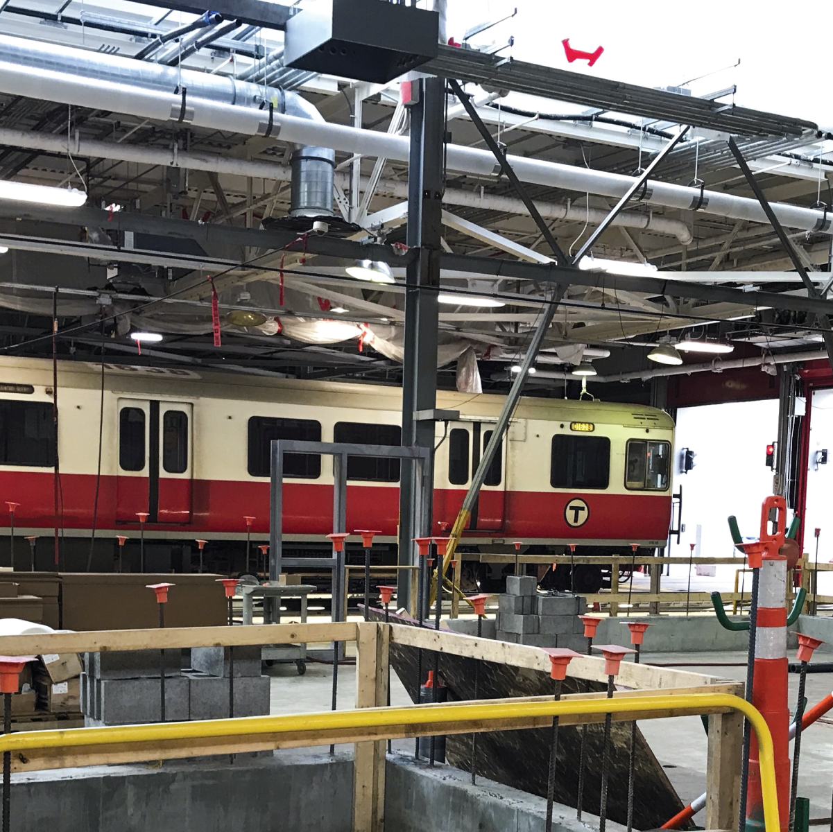 A red line train on a lift inside the Cabot maintenance facility