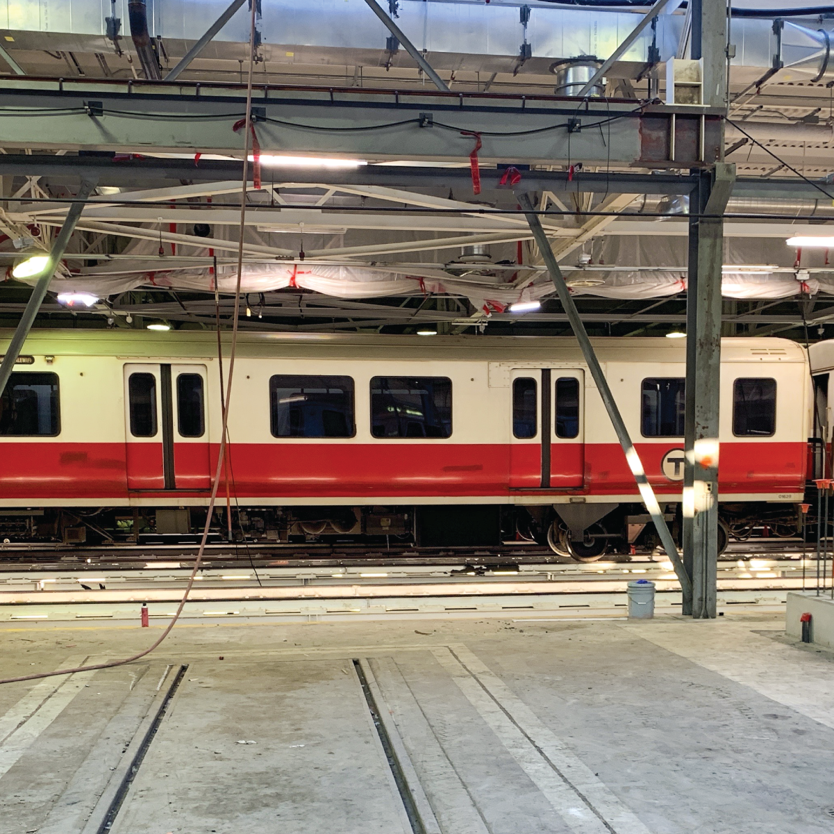 a red line train inside of a building