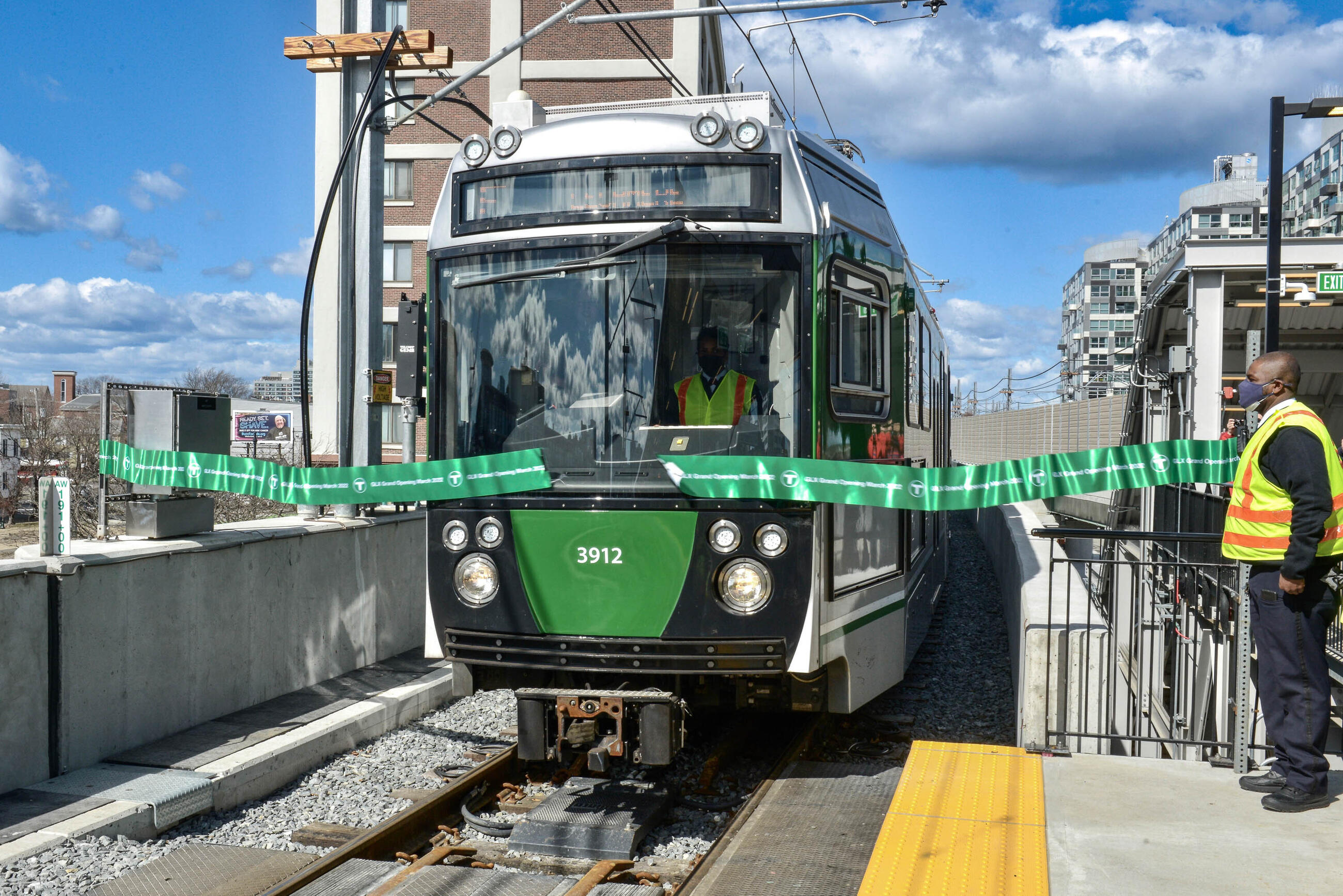 A Green Line train cuts the ribbon at the brand new, relocated Lechmere Station.