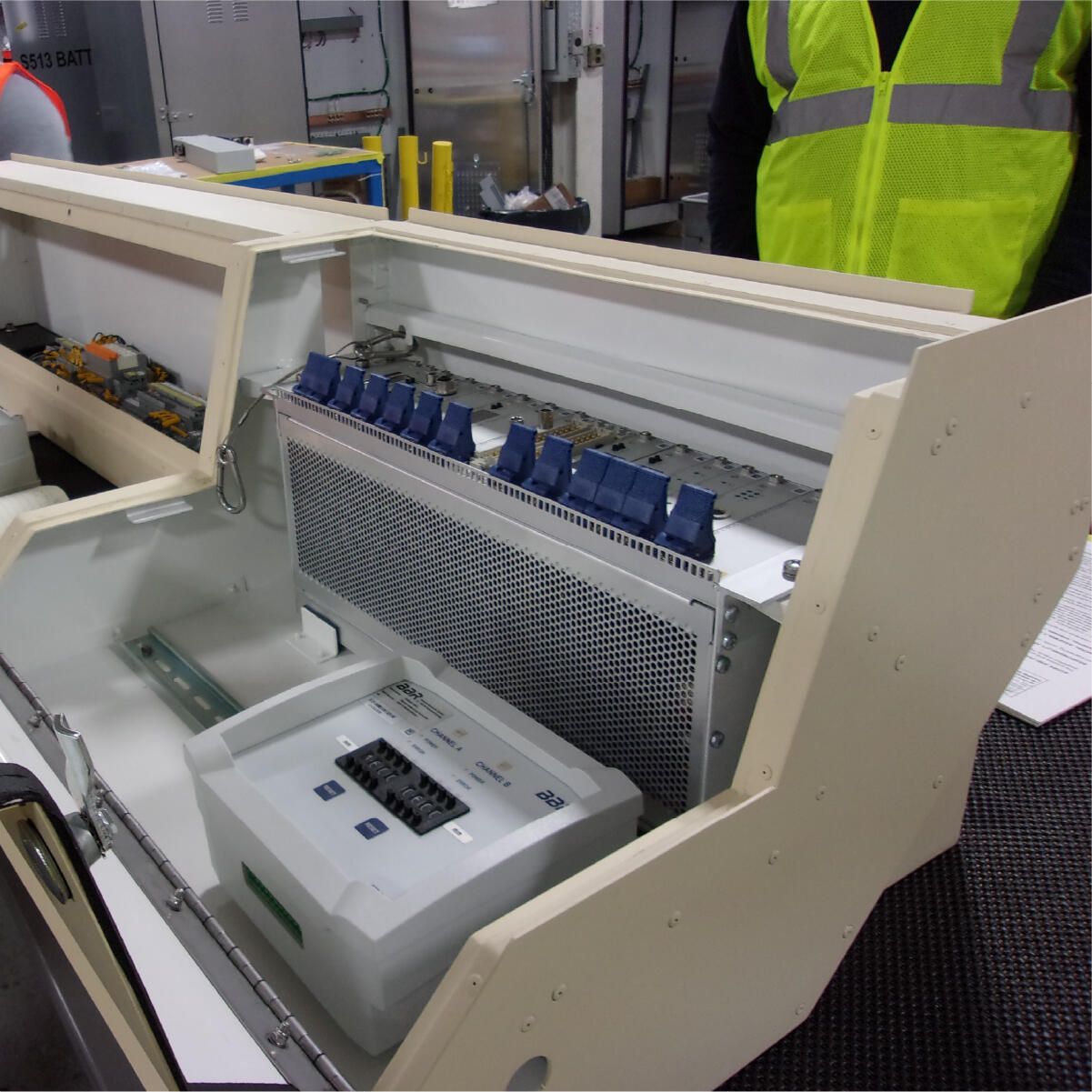 Crew members inspect GLTPS equipment at the manufacturing facility