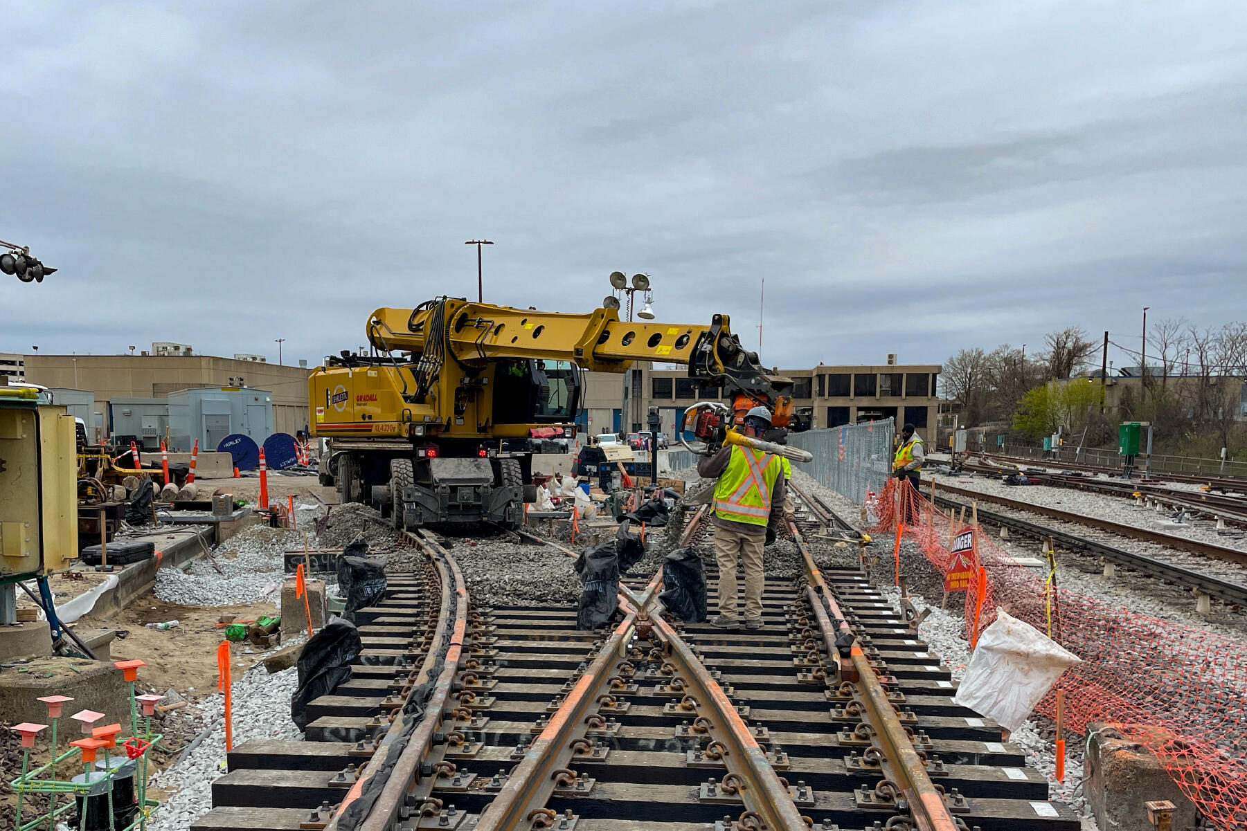 crew members and heavy machinery on criss-crossing tracks