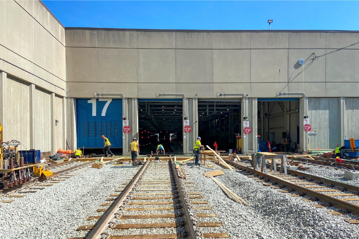 Workers install new train tracks outside the Wellington Vehicle Maintenance Facility