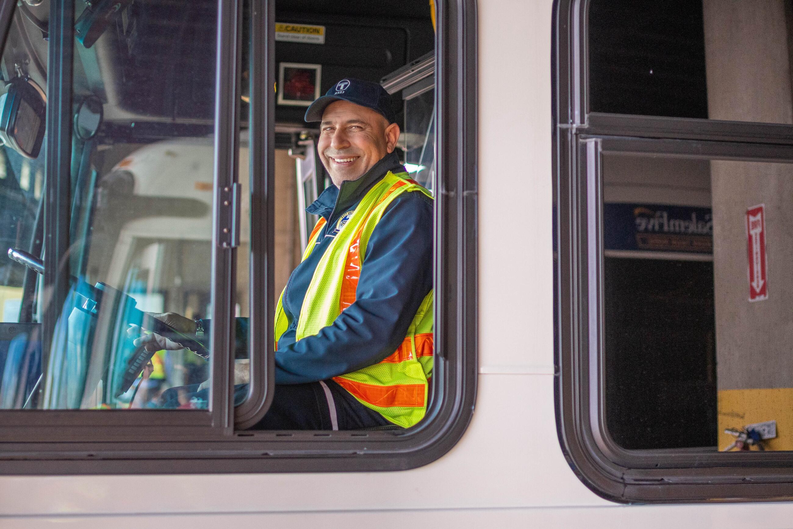 MBTA bus driver smiling outside of driver side window 