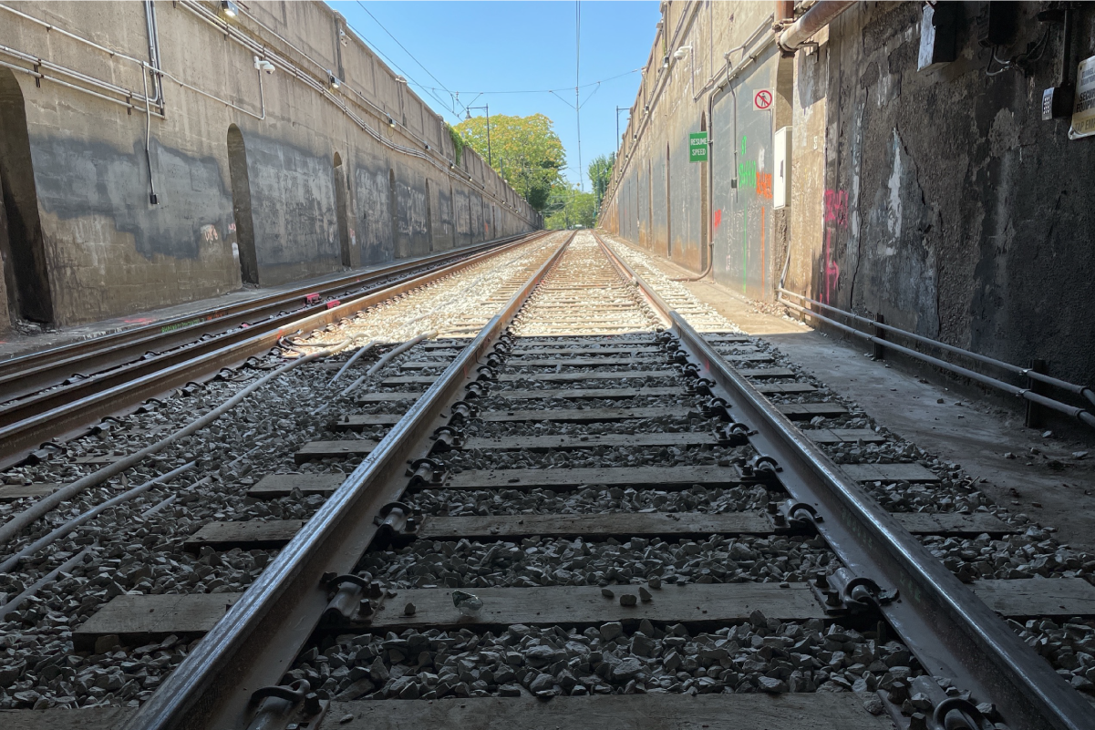 a photo of new tracks between two high cement walls on the c branch