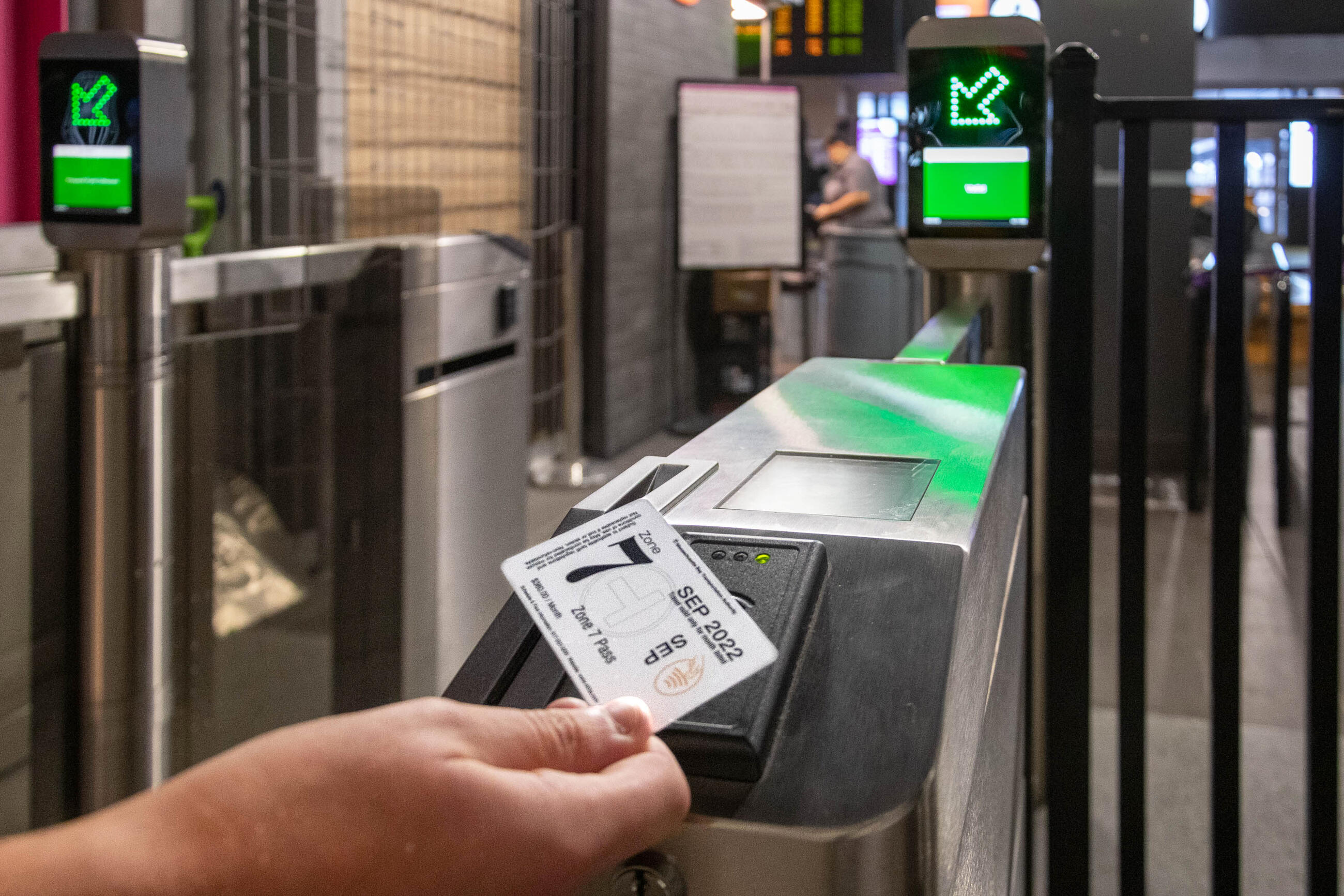 Rider using tappable ticket on new fare gate in North Station