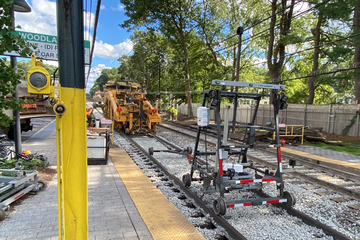 equipment on tracks in front of woodland station