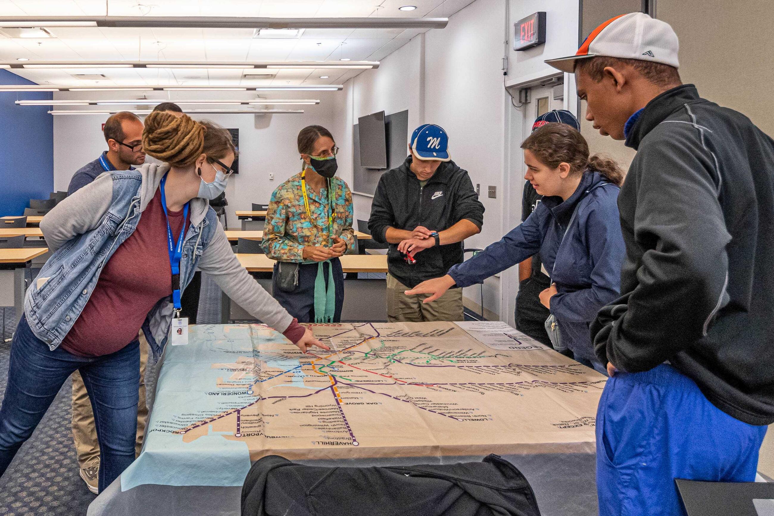 MBTA employee pointing out map information to riders at travel training session