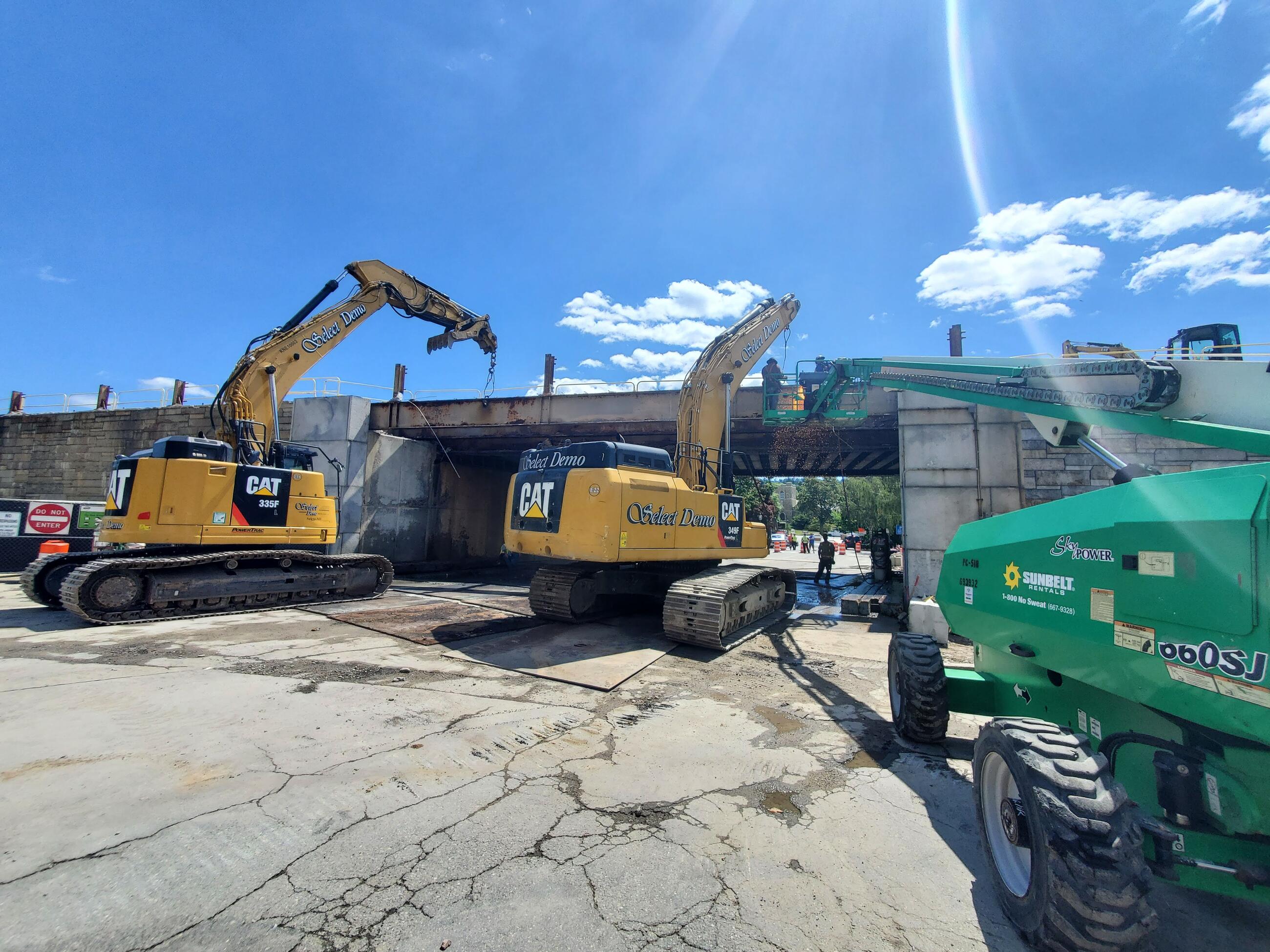 Construction vehicles doing work on bridge at Winchester Center Station (July 2022)