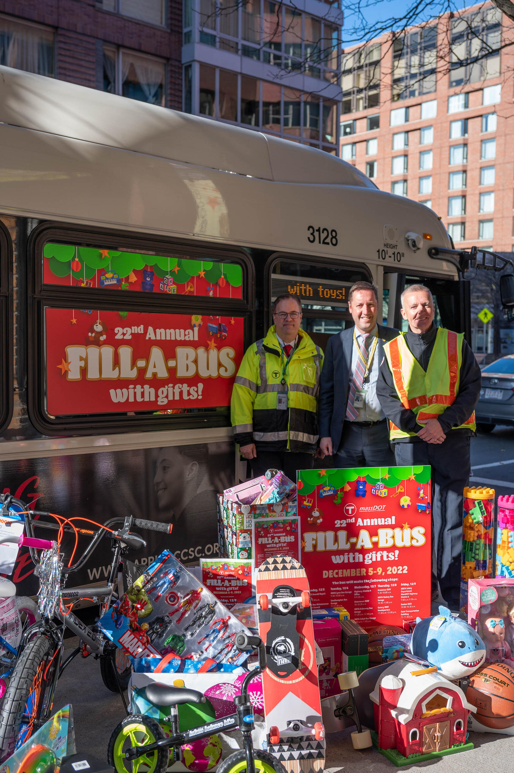 Left to Right: MBTA Graphics Design Manager David Wood, who has organized the Fill-A-Bus with Gifts event for the last five years; MBTA General Manager Steve Poftak; and MBTA Bus Operator Mike Broderick, who drives the holiday bus route each year.