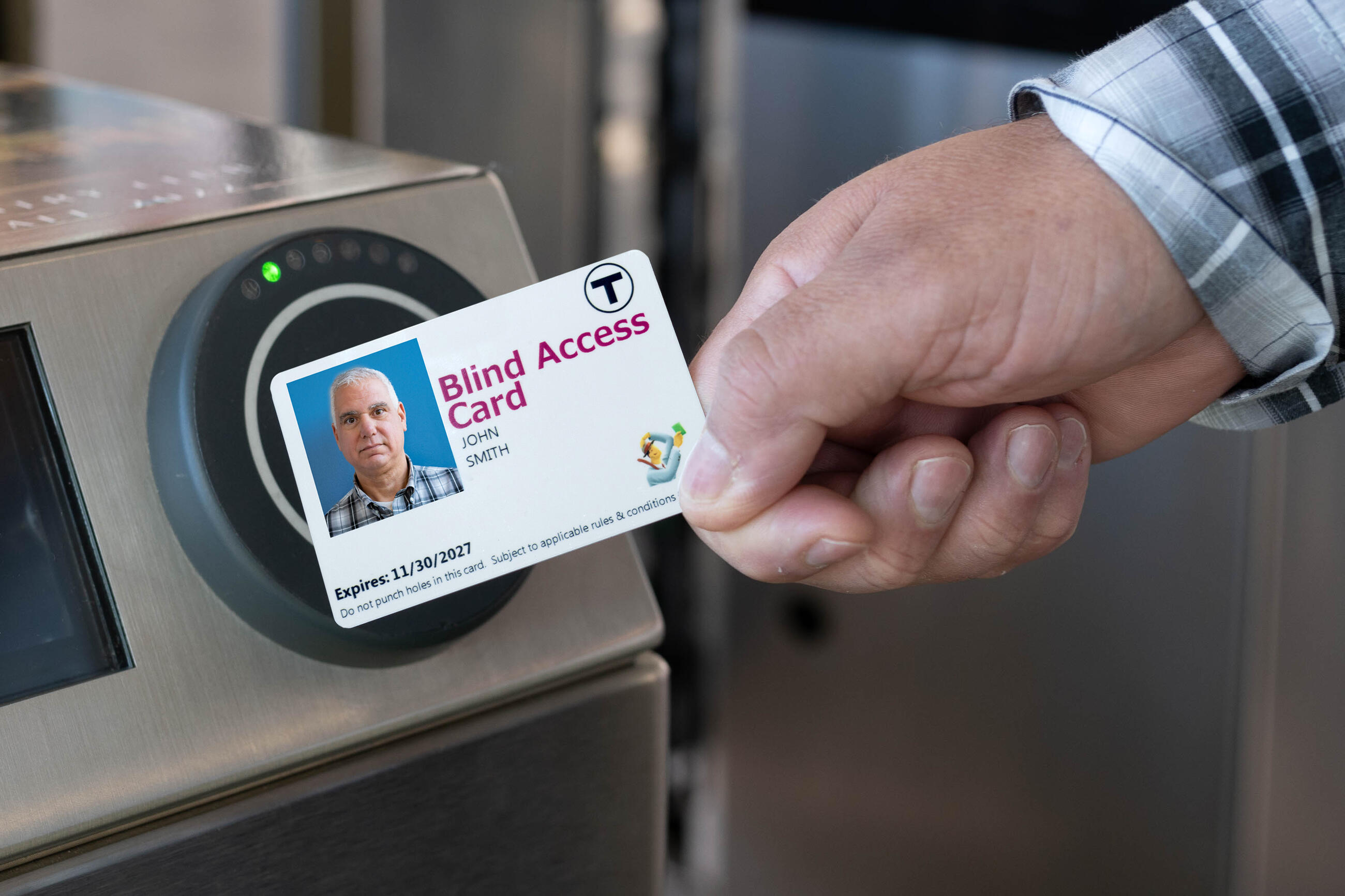 Hand holding Blind Access Card and tapping at fare gate 