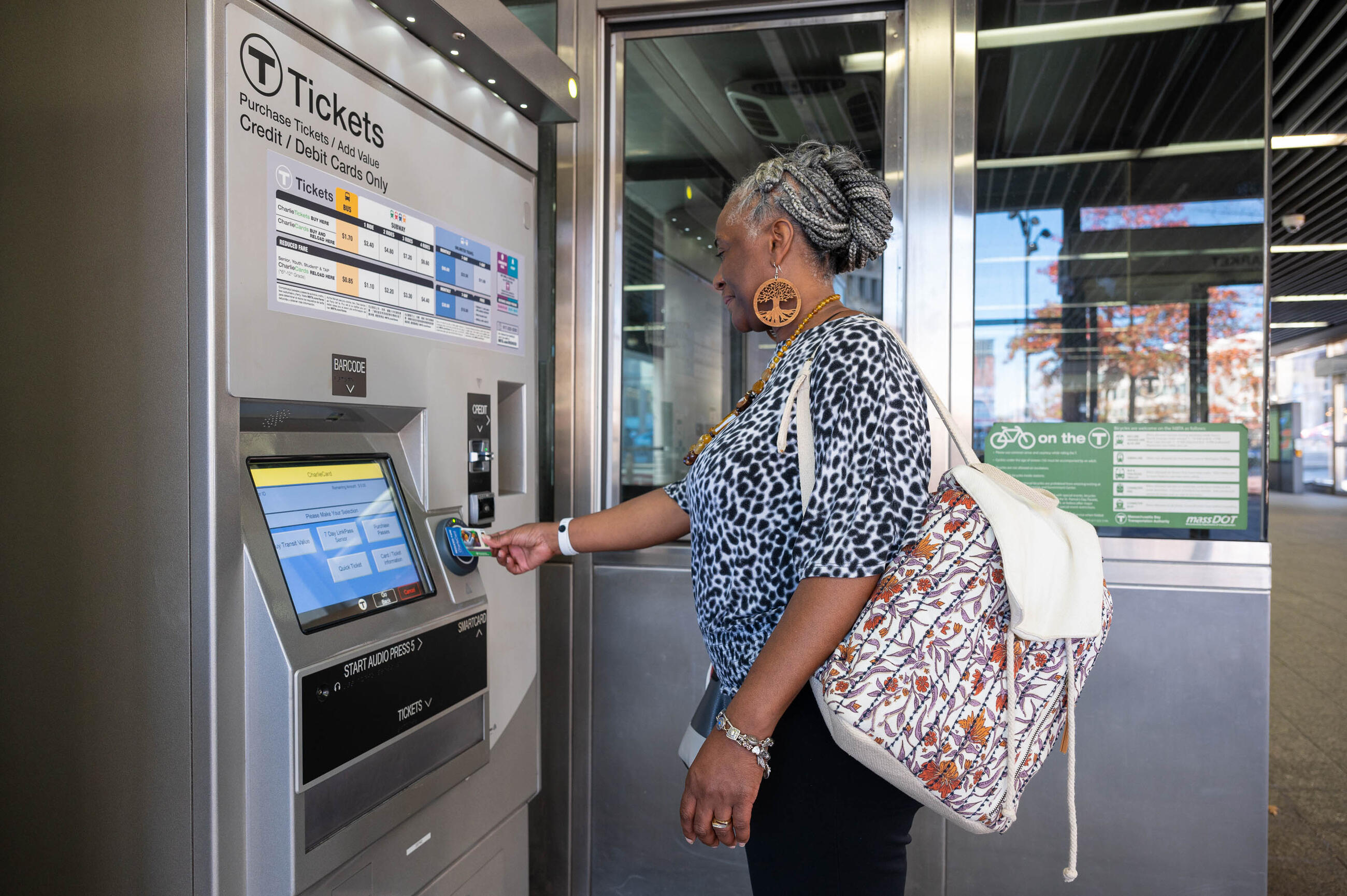 Rider tapping Senior CharlieCard at fare vending machine