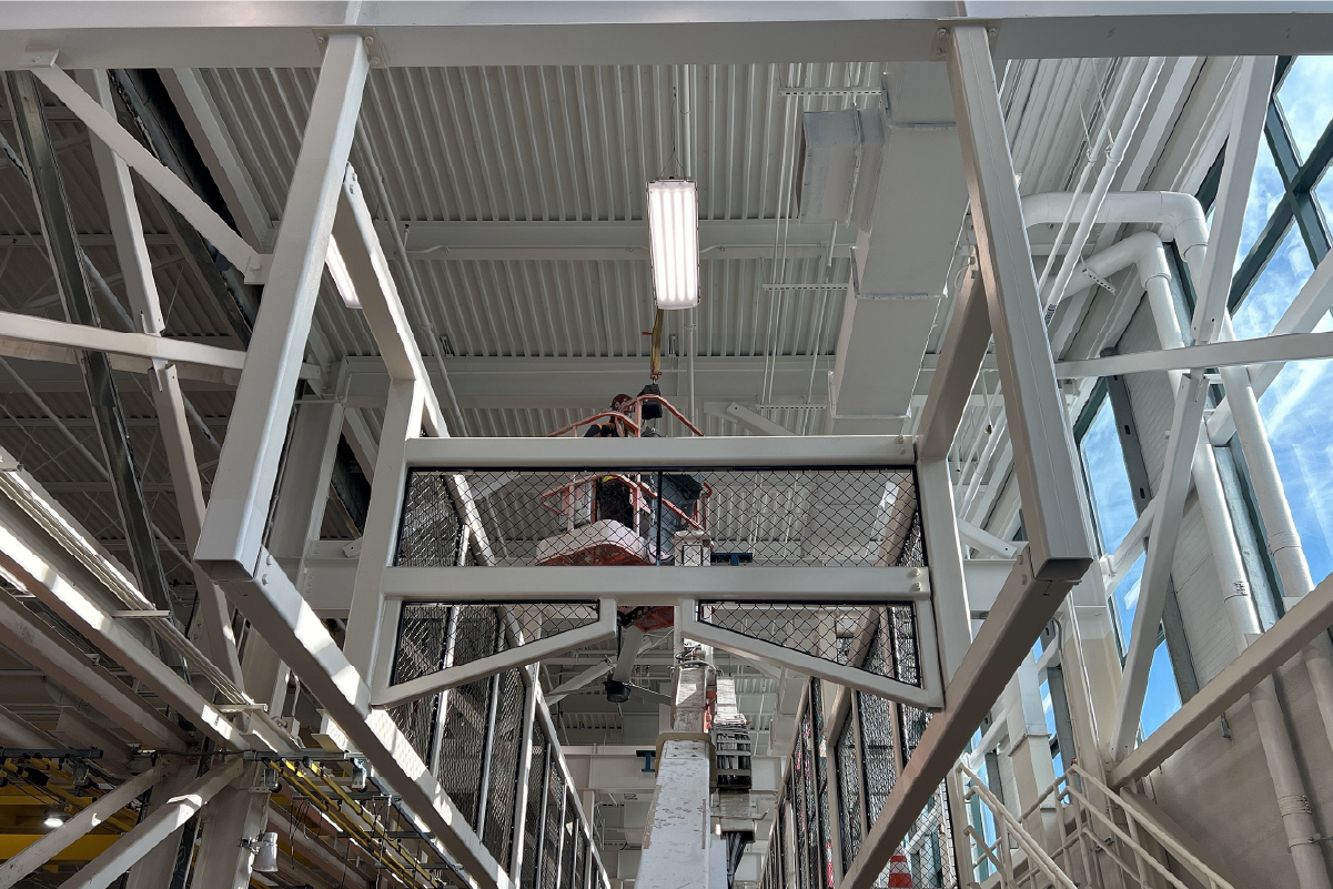 crew member working in a lift near the ceiling